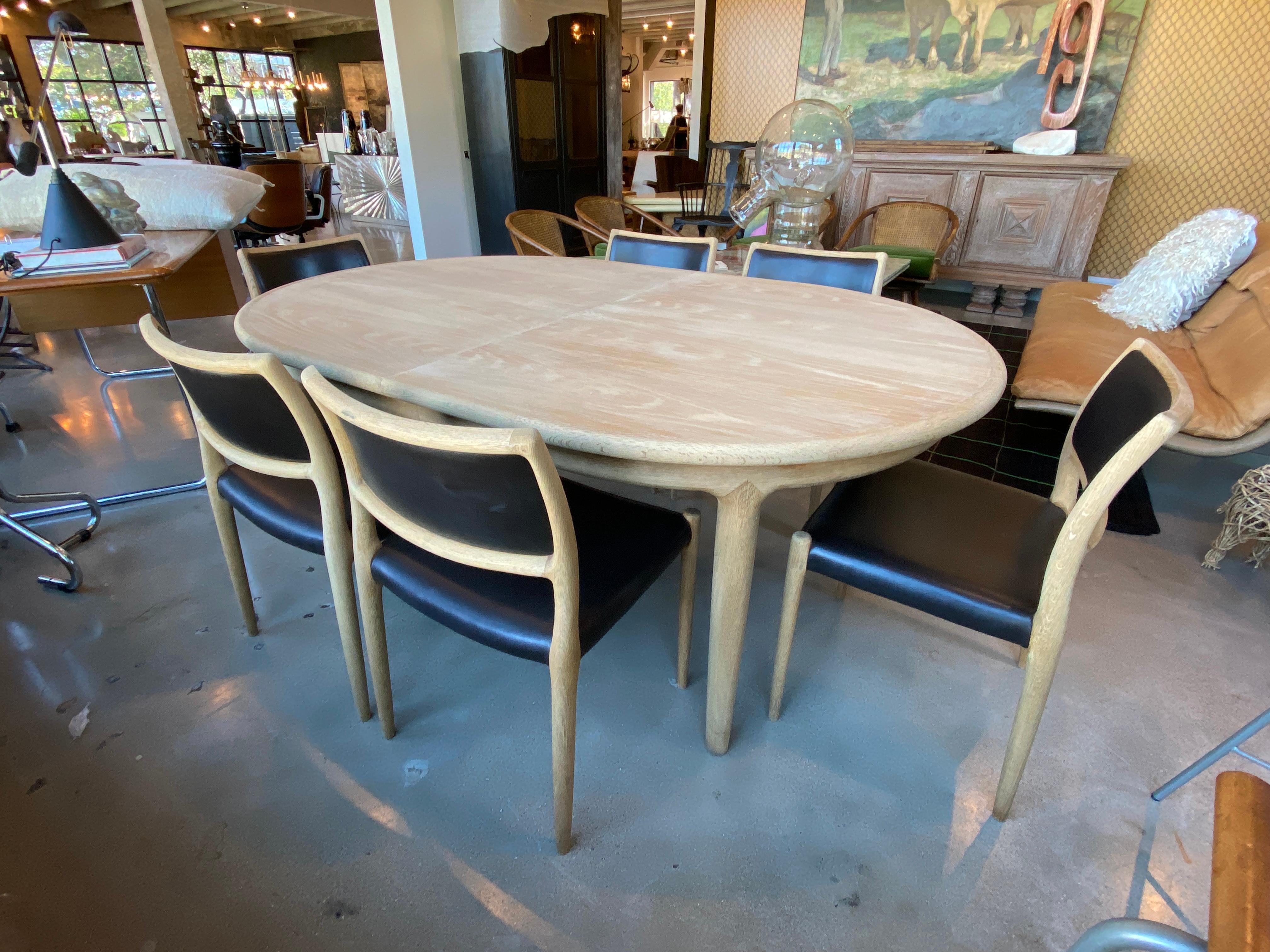 Niels Otto Møller for J.L. Møllers Møbelfabrik Model 80 dining set. Danish 1960s Mid-Century Modern design includes oval dining table and 6 comfortable side chairs. The dining table has built-in leaves that remain within the apron cavity when not in