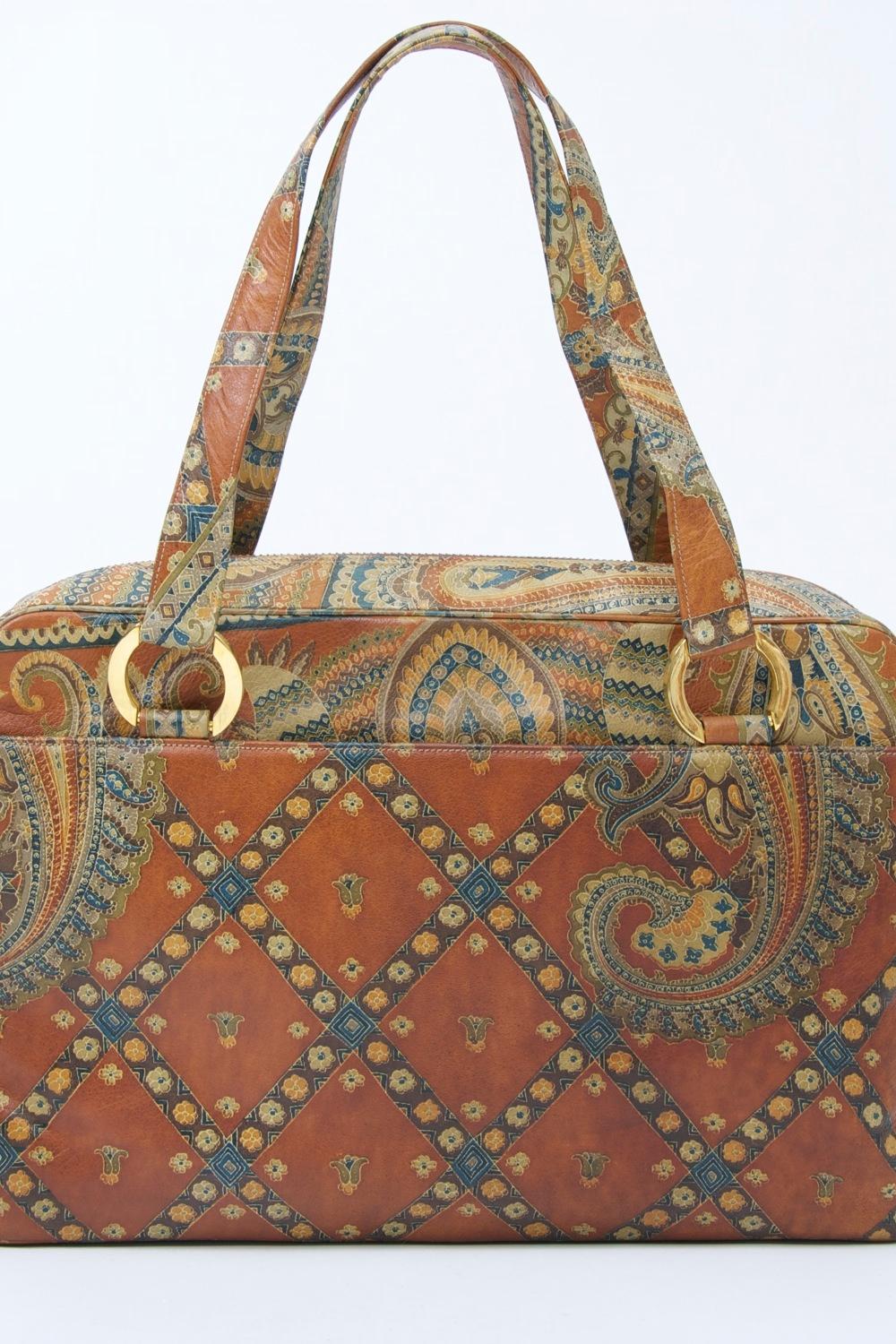 MM (Morris Moskowitz) was one of America's best handbag producers during the mid twentieth century. This example features an innovative leather printing technique based on the paisley design. The large tote-style bag has two matching handles