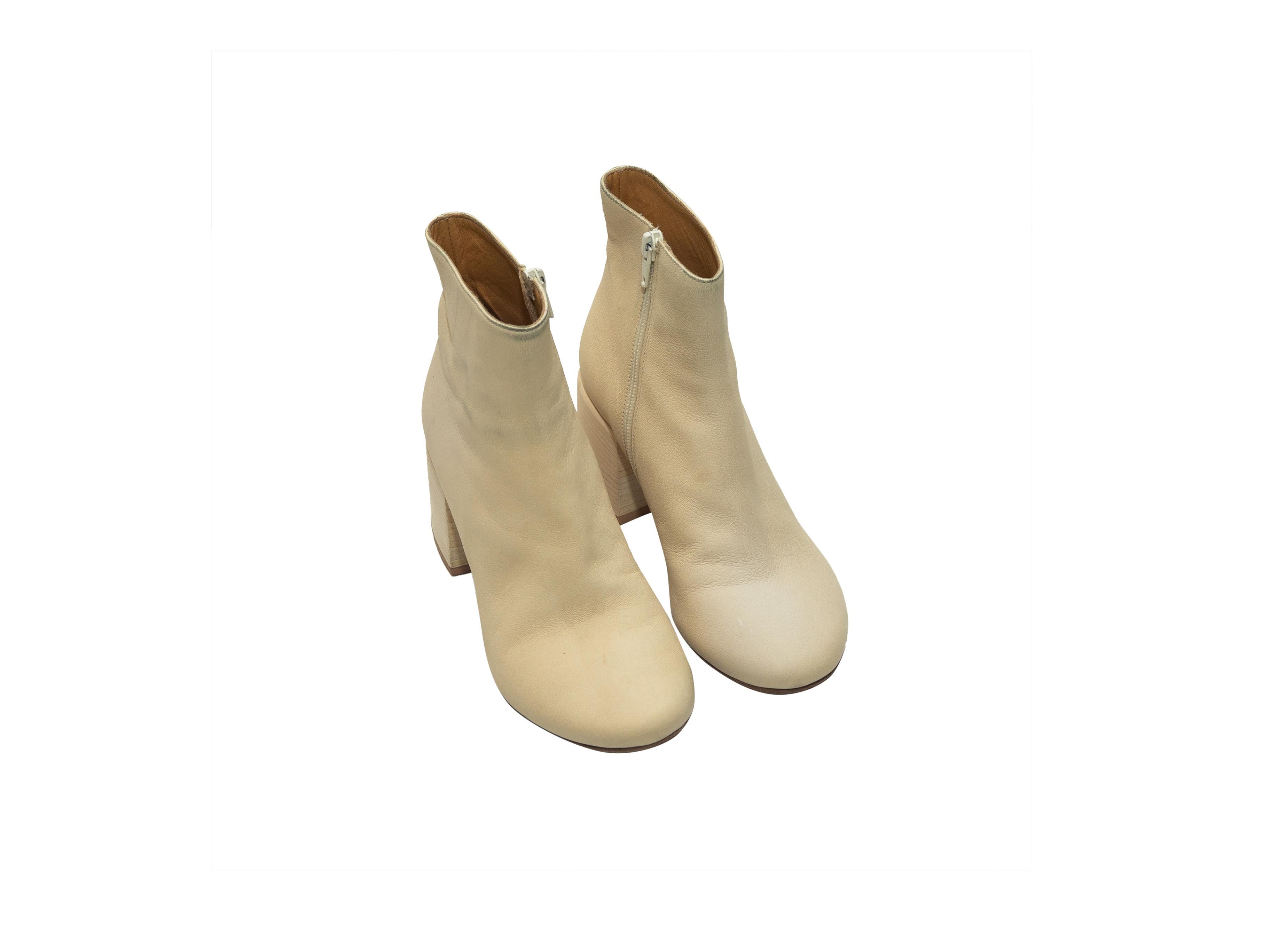 Product details: Cream leather round-toe ankle boots by MM6 Maison Margiela. Stacked heels. Zip closures at inner sides. Designer size 37. 3