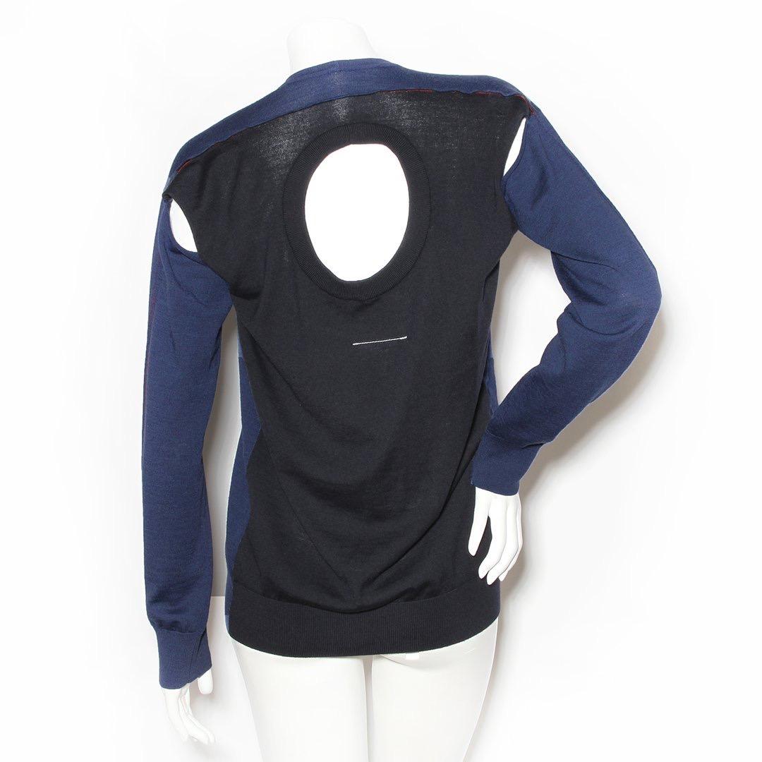 Cutout sweater by MM6 Margiela
Scoop neck with back cutout (or double neck line)
Color blocked black and blue  
Dual shoulder cutouts 
Cuffed wrists and bottom hem 
Decorative red stitching across back 
100% wool
Made in Romania
Condition: New with