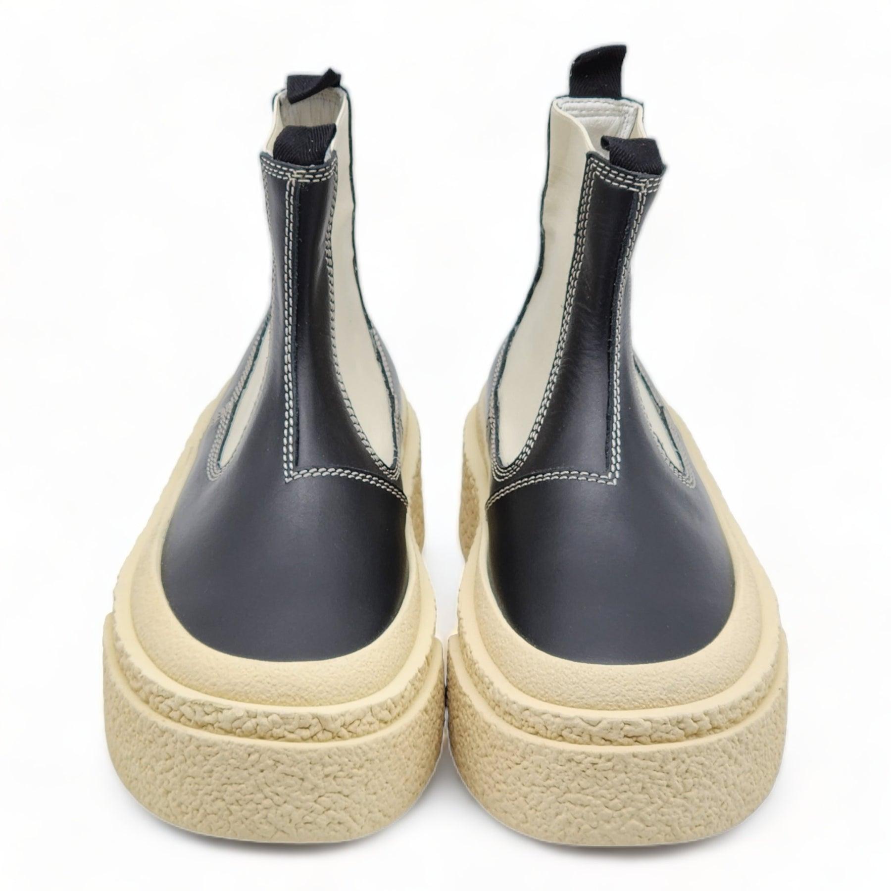 MM6 Maison Margiela Round-toe Leather Ankle Boots.

Additional information:
Material: Calf leather
Elasticated side panels
Slip-on style
Round toe
Chunky rubber sole
Color: Black/vanilla white
Size: 5.5 US
Country: Italy
Code: