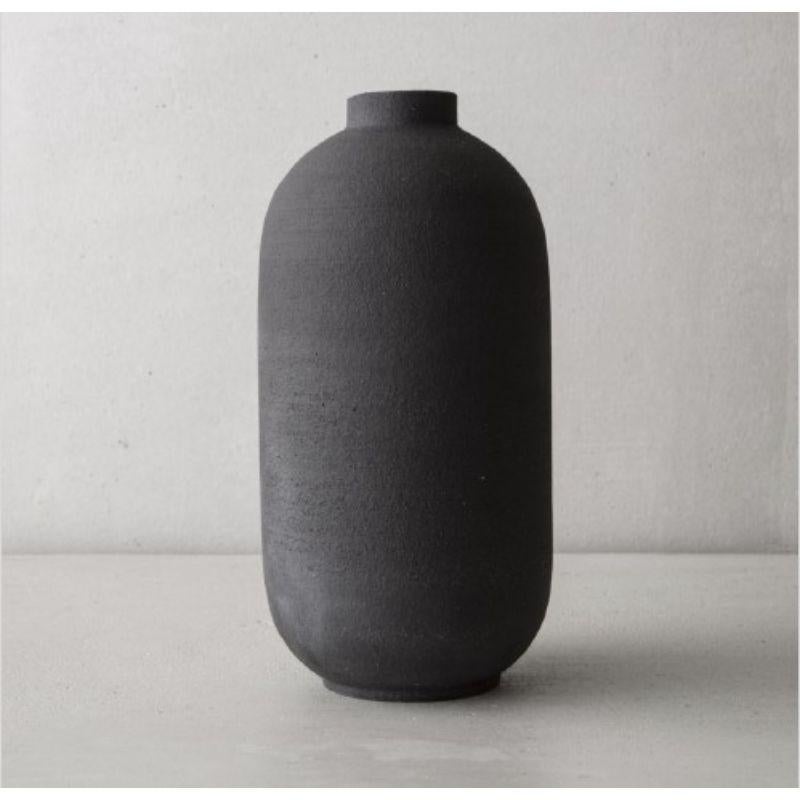 Mn L big vase by Josefina Munoz
Mn LARGE collection
Dimensions: H 35 x D 18 cm
Material: Ceramics (Black Sandstone and Transparent Enamel) 

Available in: Small, and Medium. 

Ceramic handcrafted vases, glazed inside. This pieces of pure and