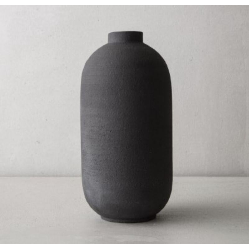 Mn Medium vase by Josefina Munoz
Mn collection
Dimensions: H25 X ?13,5 cm
Material: Ceramics (Black Sandstone and Transparent Enamel) 

Available in: Soliflor, and Small. 

Ceramic handcrafted vases, glazed inside. This pieces of pure and