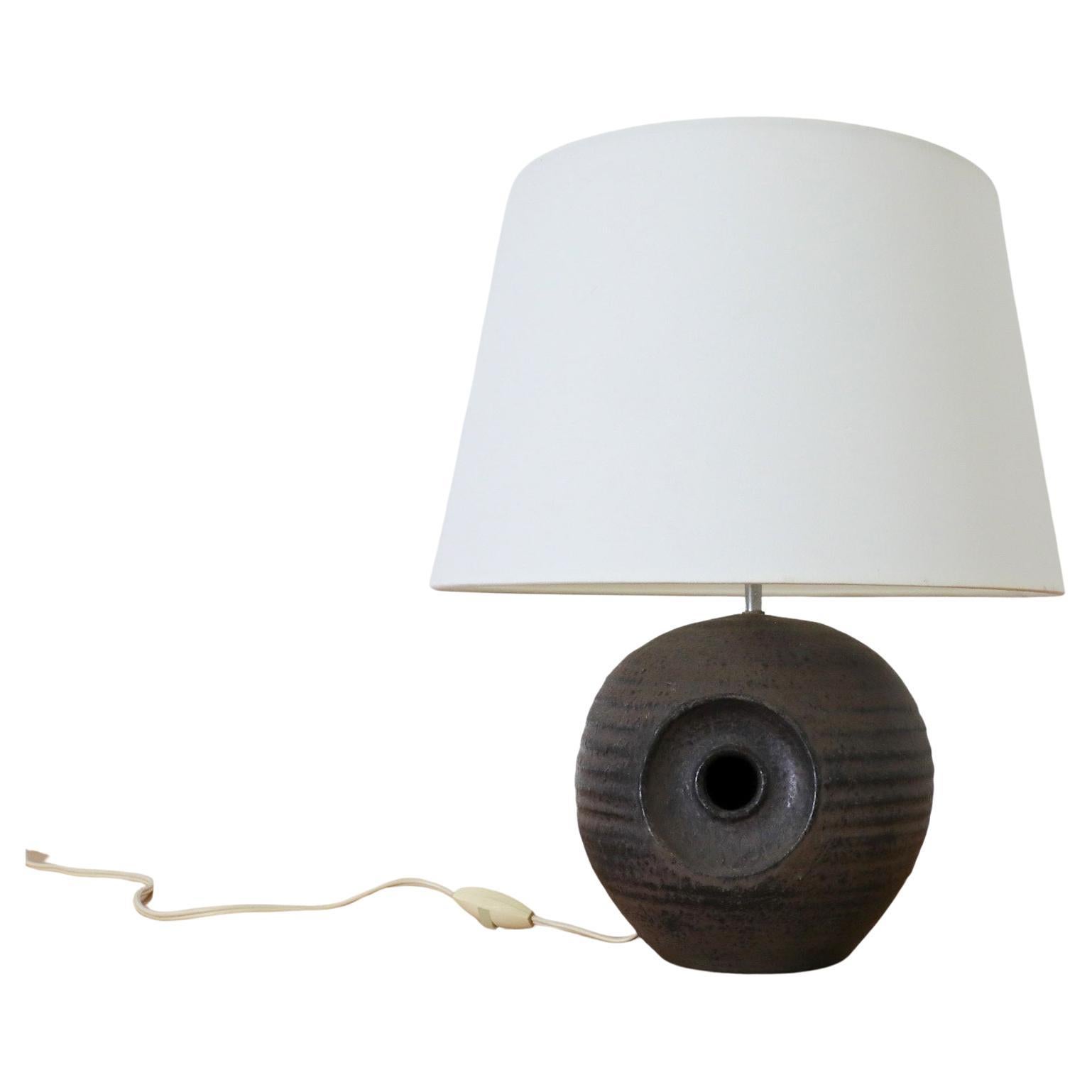 Gorgeous Mobach dark purple ceramic globe table lamp with cut out design, original socket and newer linen shade. Signature grooved texture with matte dark purple glaze and hints of army green. In good original condition with wear consistent with age