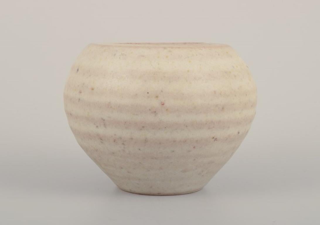 Glazed Mobach, Netherlands. Two ceramic vases with glaze in light tones.