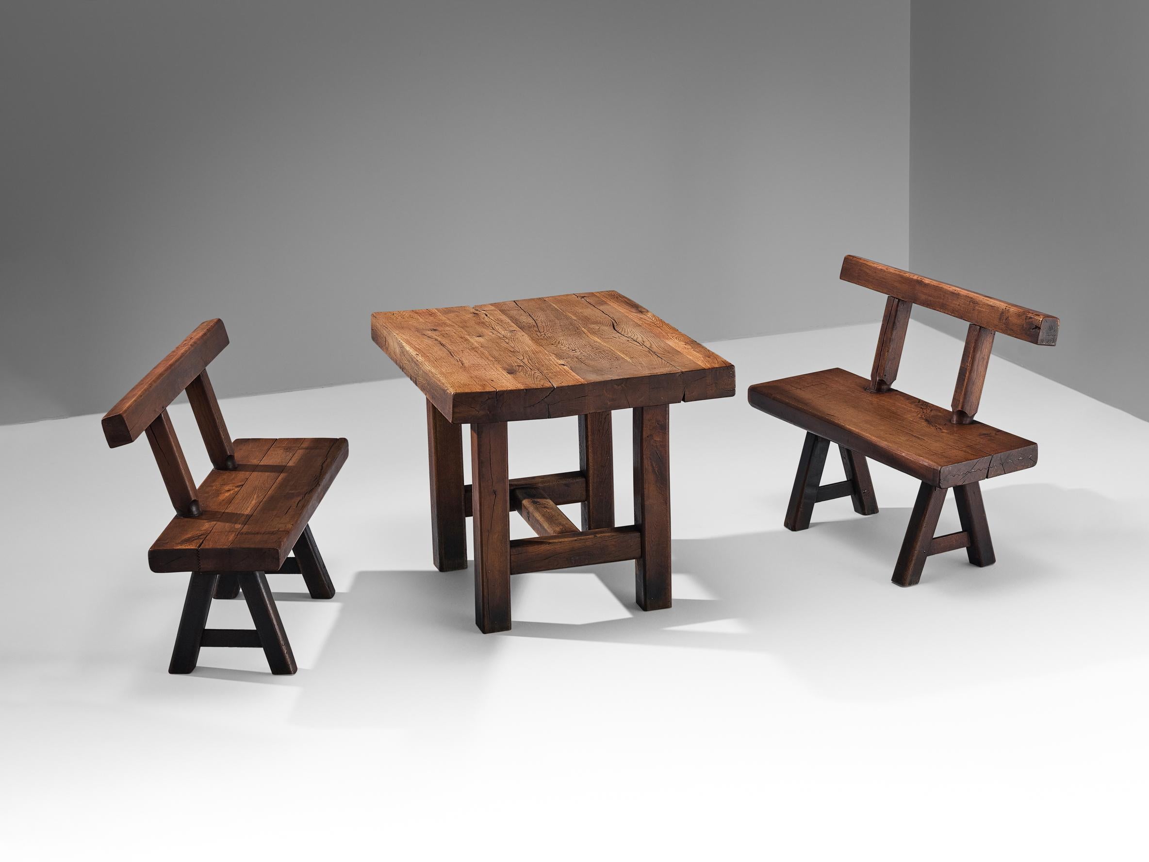 Mobichalet, set of dining table and a pair of benches, oak, beech, Belgium, 1950s.

This rustic dining set will come forward nicely in a relaxing atmosphere, like a patio or a studio space. The Brutalist appearance is expressed through robust