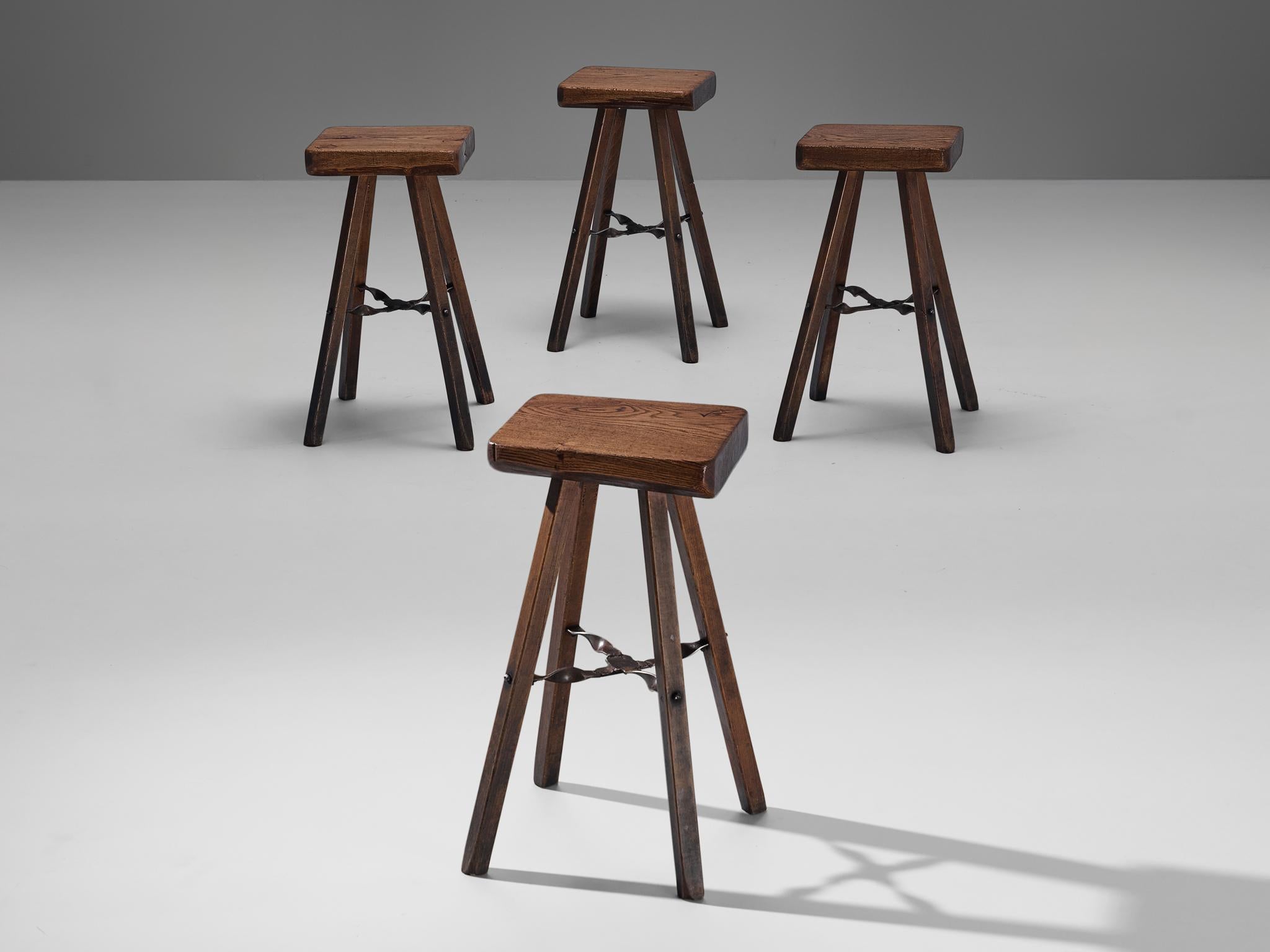 Mobichalet, high stools, stained pine, iron, Belgium, 1950s.

These high stools are produced by Mobichalet in the 1950s. The stools are all slightly different in form, imparting the pieces with a rustic and naturalistic look. 
The chairs have a