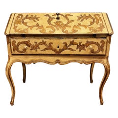 Lacquered wooden cabinet with a drop-down door, decorated with plant scrolls, Italy