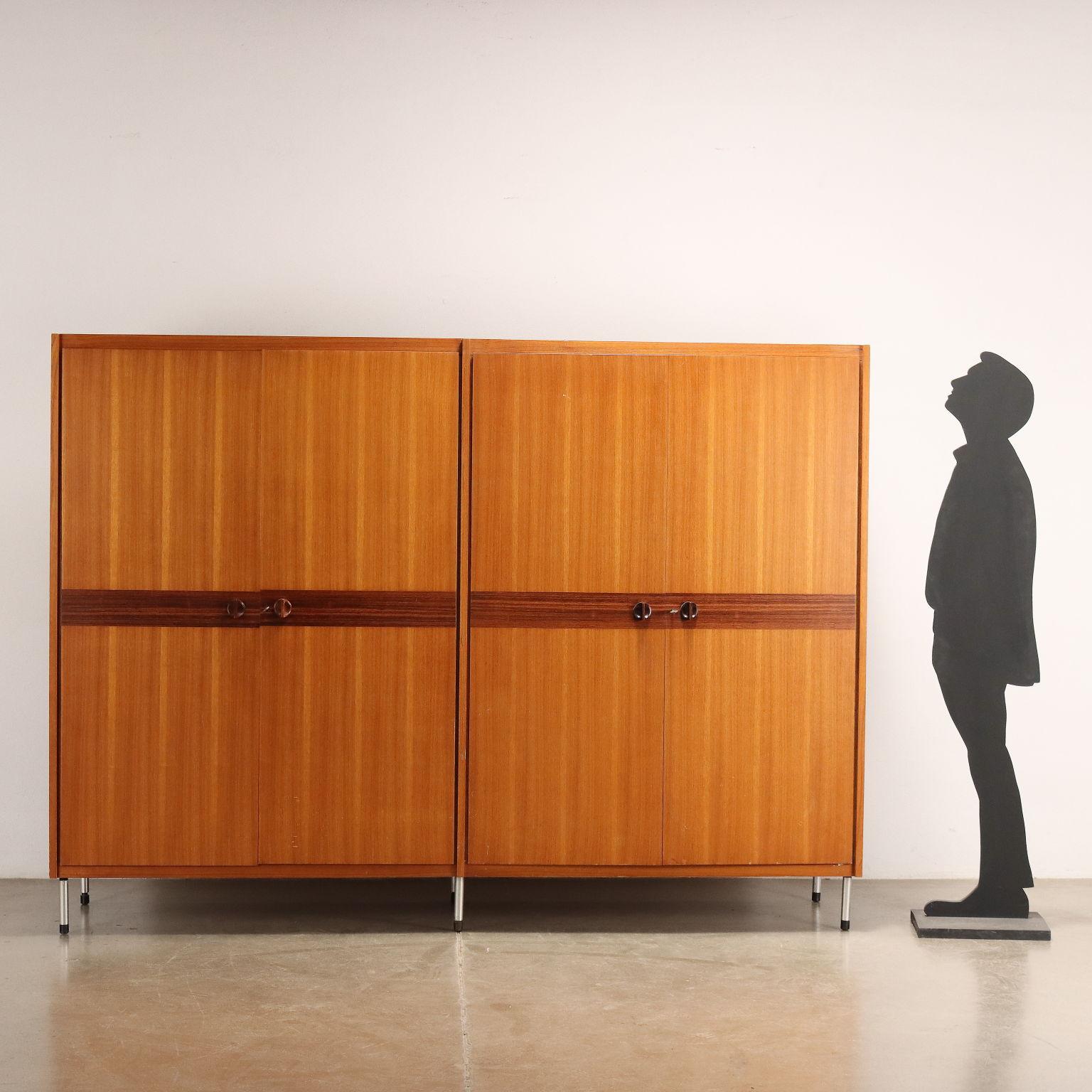 Cabinet with 4 hinged doors, made of teak veneer wood and mahogany band, metal legs. Good Condition