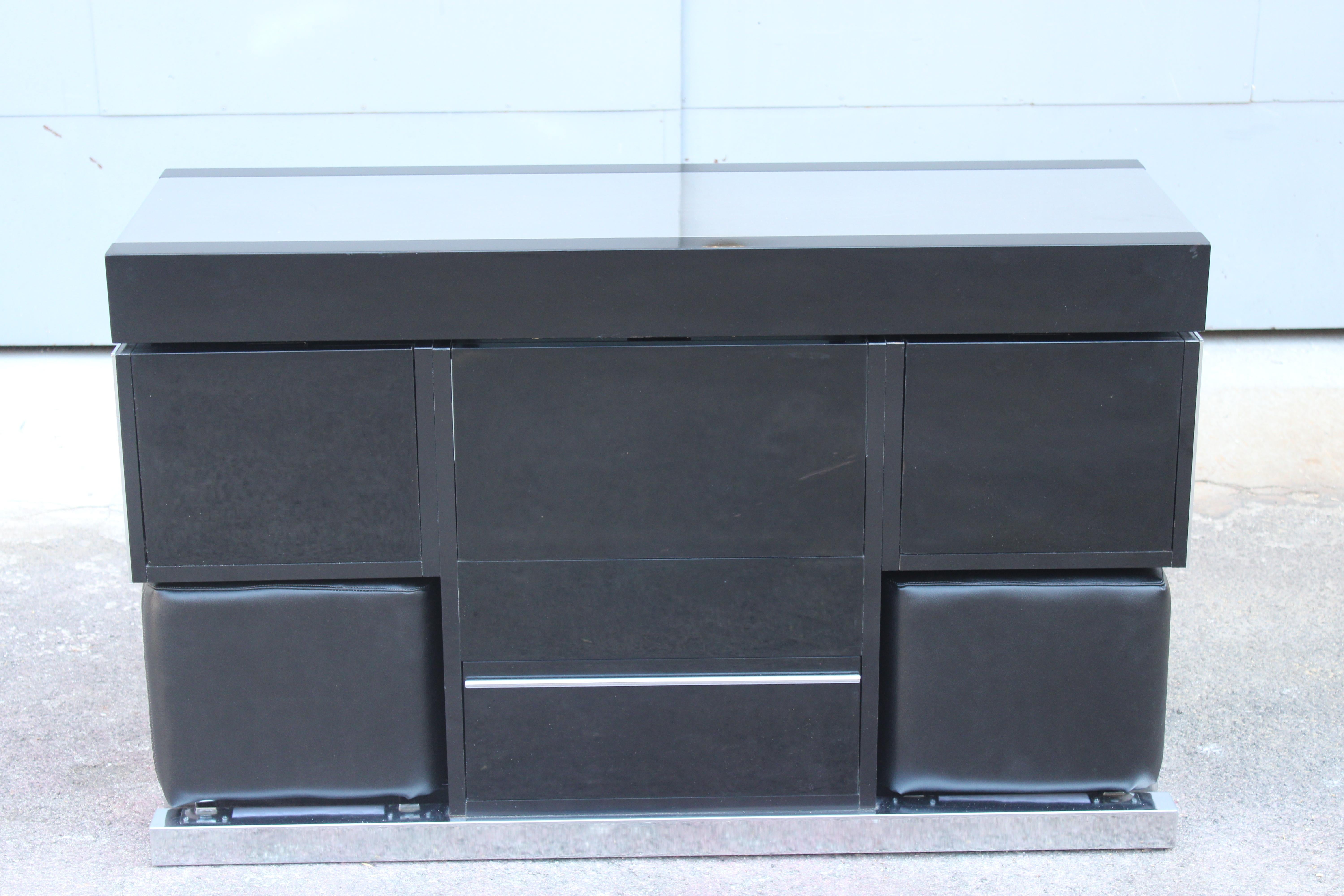 Bar cabinet with slide top door and front flaps, with built-in retractable stools, the steel metal top has some scratches, the black frame also has some scratches, as pictured.