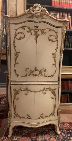 Cabinet with lacquered wood flap, carved with gilt friezes, Italy