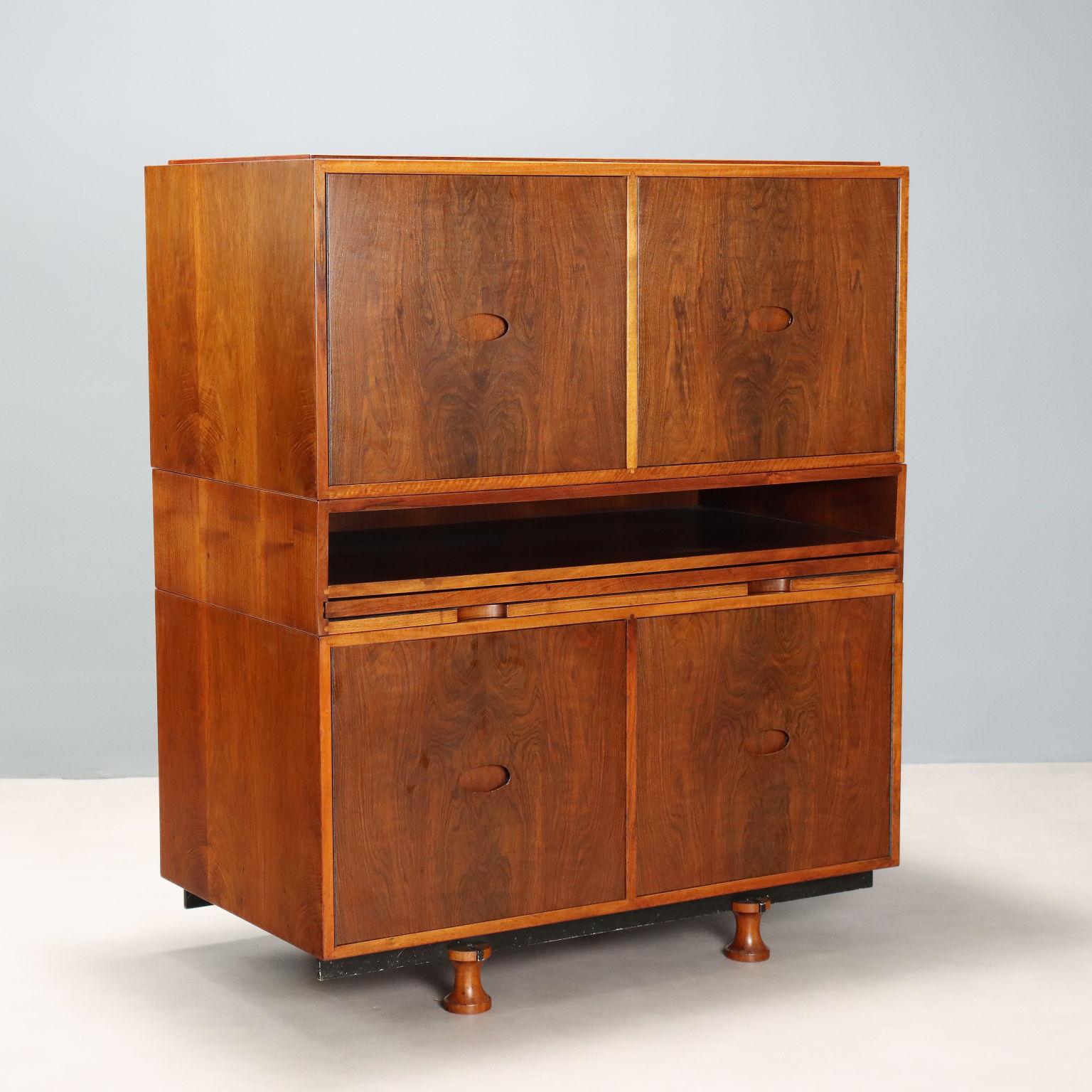 Meuble vintage en bois avec placage de bois exotique caractérisé par trois modules, dont deux avec portes à charnières et étagères internes, un avec compartiment ouvert et plateau de bureau extractible. Un meuble restauré dans nos ateliers qui porte