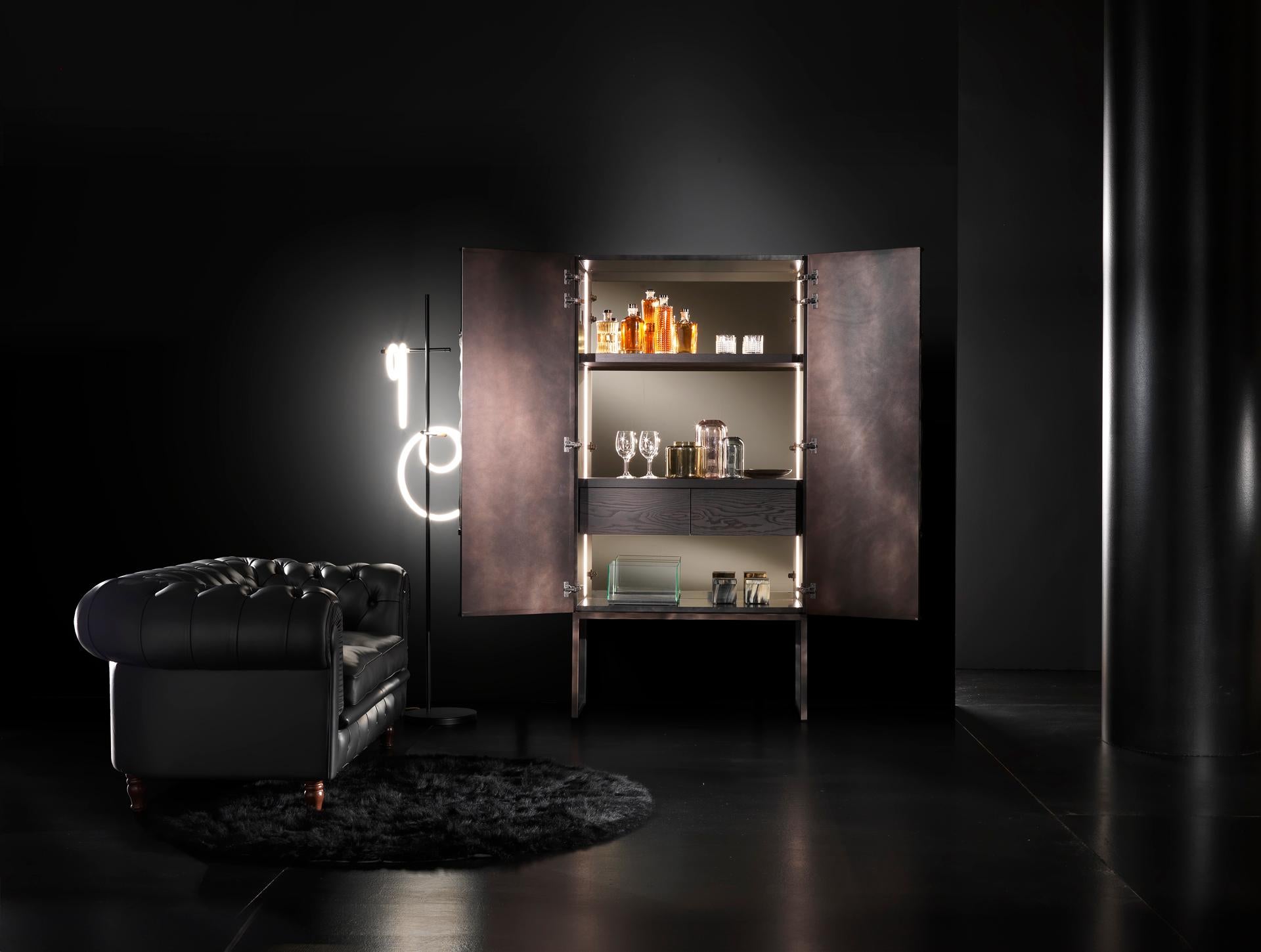 Mobile Con Tondo Credenza by Francesco Profili
Dimensions: W 100 x D 50 x H 200 cm 
Materials: Plywood, MDF, Ash Veneer, Bronzed Mirror, Wood, Wooden Ornamen.

The heart of this sideboard is its decorative element placed at the center, a round