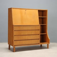 1960s maple storage cabinet with a drop-down door, made in Italy.