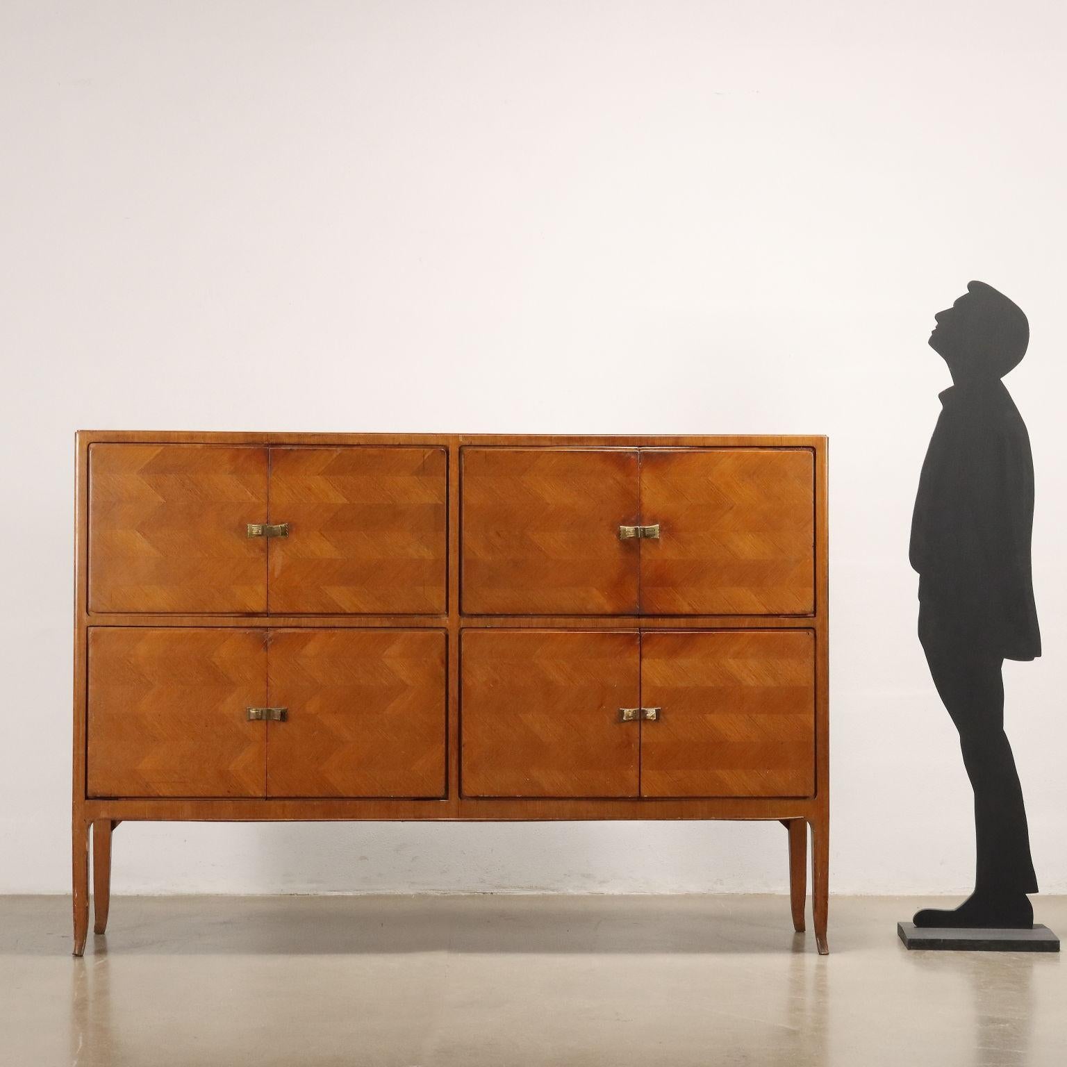 Sideboard with hinged doors, made of mahogany veneered wood and brass handles. Fair condition.
