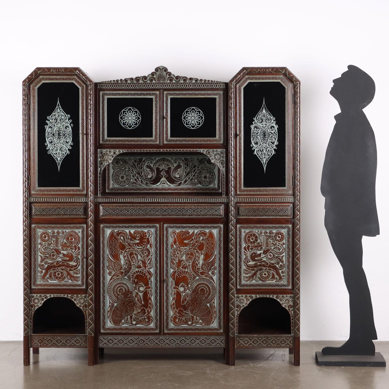 1950s hall furniture made by artist Rino Galbiati. An architectural piece of furniture with an ethnic flavor, it has doors in the lower part, hidden drawers in the center band and in the raised open compartment, and four doors with painted glass.