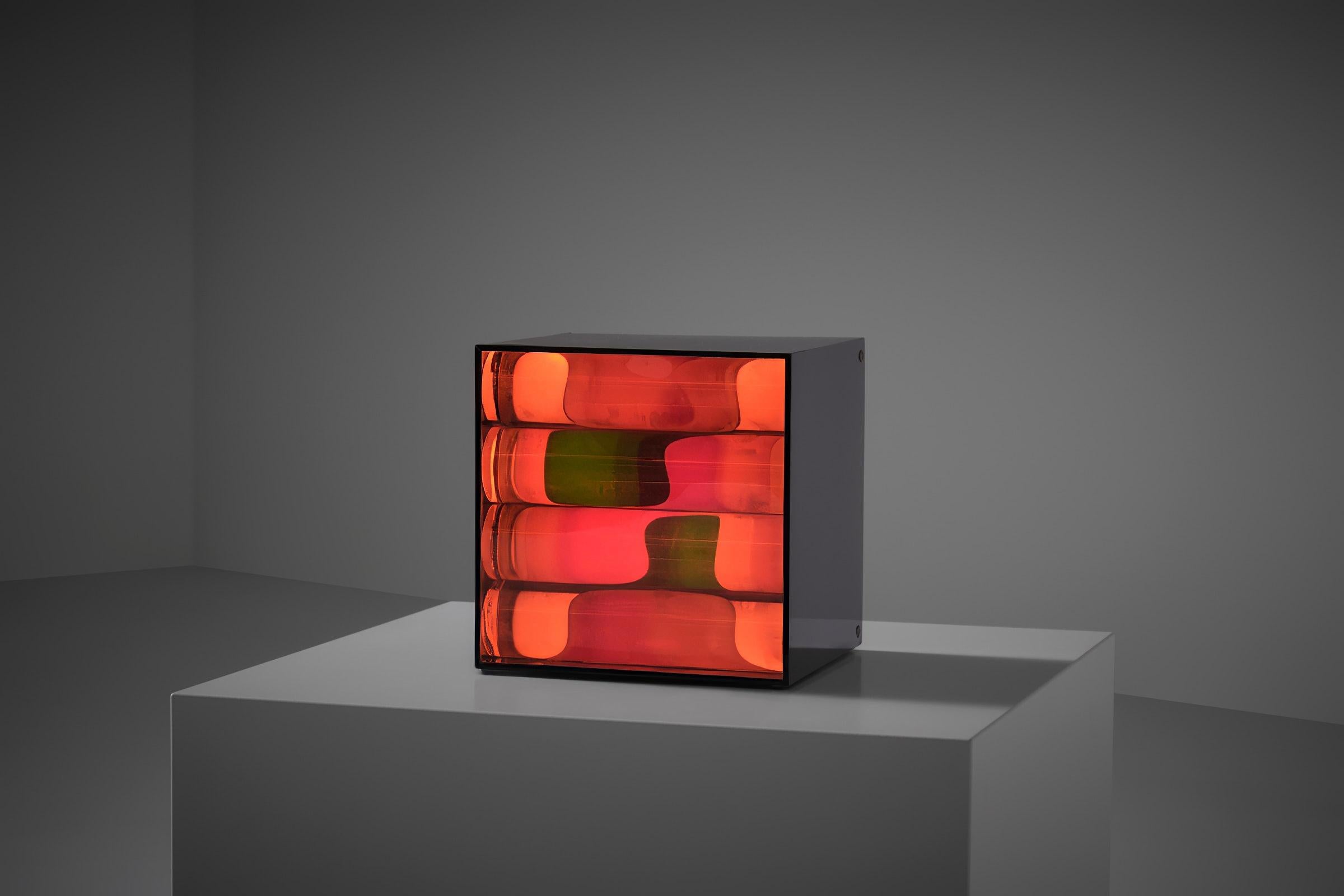 Mobile Kinetic Light box by Perla Benveniste, Buenos Aires 1970s. Intriguing early work from the early seventies, crafted from a black methacrylate box with a transparent front hiding circular orange colored methacrylate tubes, a white rotating