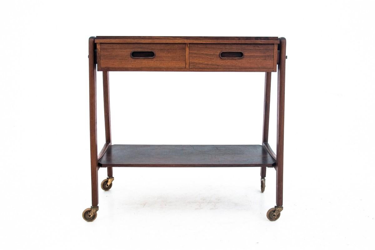This trolley comes from Denmark from the 1970s with a minimalistic form characteristic of Scandinavian design. Spacious 2 drawers. It is made of teak wood, table top from rosewood. It is maintained in very good condition.