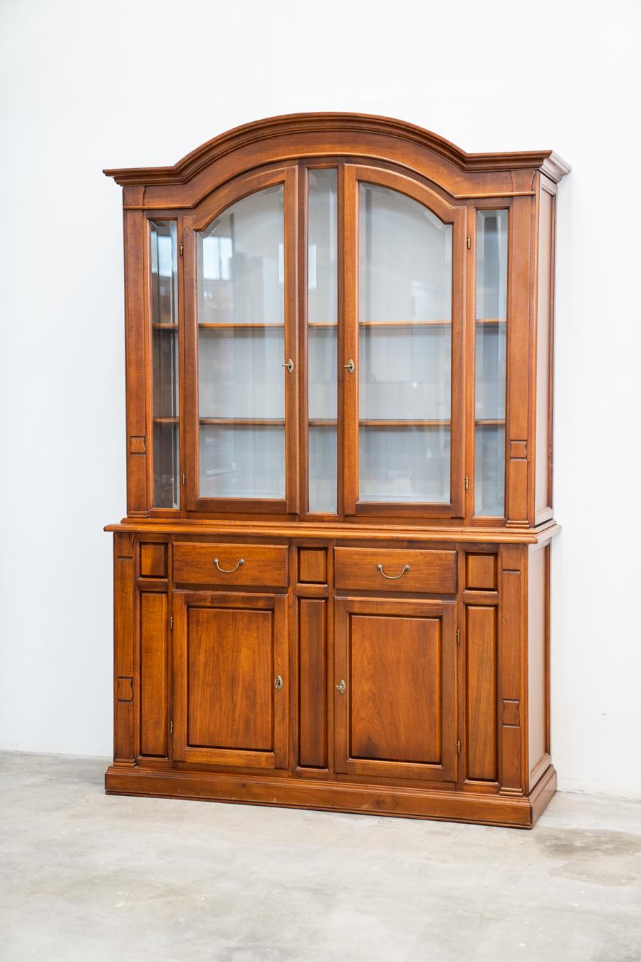 Arte Povera style display cabinet 1980/1990		
DESCRIPTION	It consists of two pieces of furniture made of beech carved wood, walnut stained. Handles 	in brass. The doors are made of glass with wooden shelves inside.
	Measurements H210 x W148 x D50 -