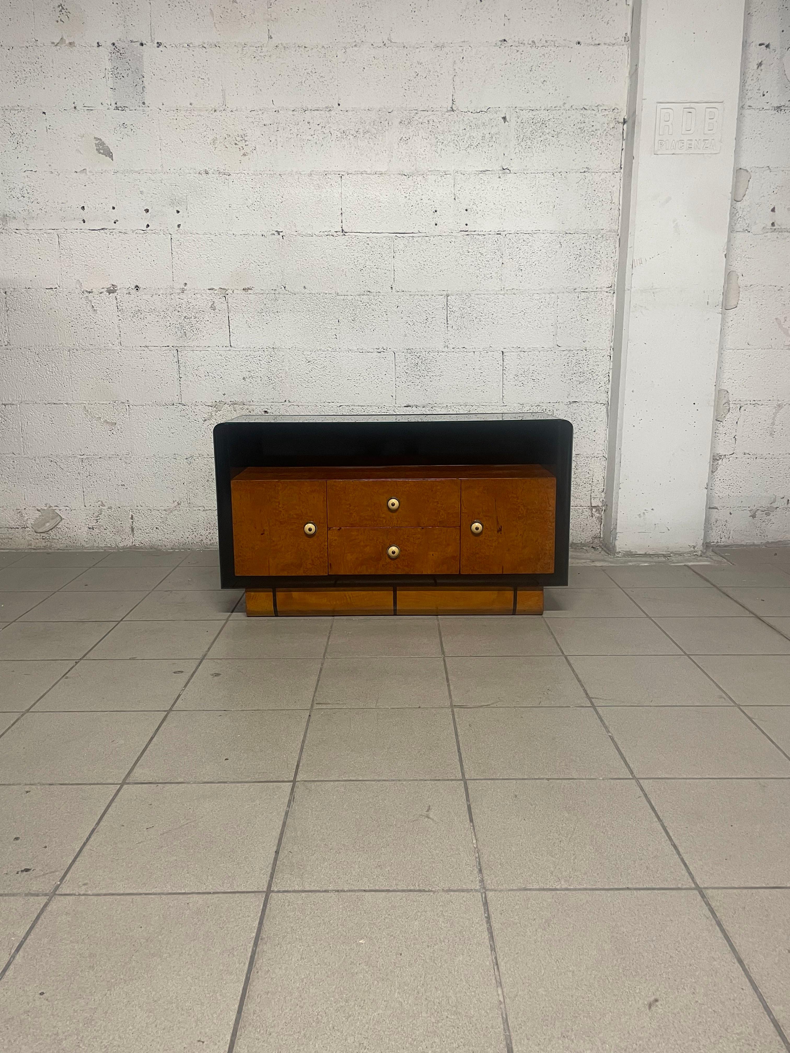 Low deco cabinet with drawers and doors dating from the 1930s-1940s.

Given its shallow depth, it is also perfect for use as a console table.
The frame of this cabinet combines Thuya burl and ebonized wood with crystal top for the top.

The cabinet