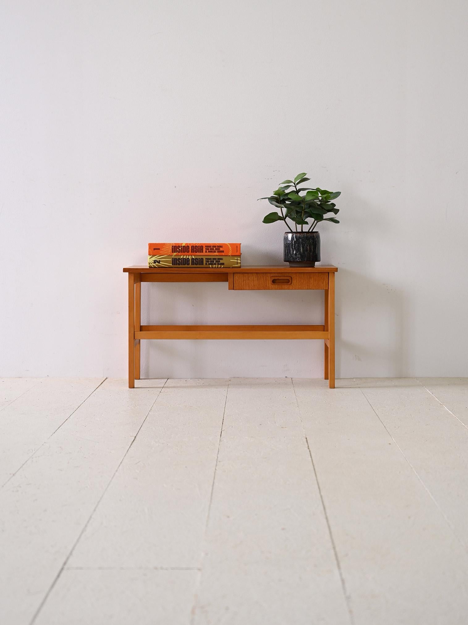 Scandinavian teak coffee table with drawer.

This Swedish teak coffee table from the 1960s features clean, simple lines that lend a timeless elegance. Square legs add sturdiness to its appearance, while the overall shape is enhanced by a drawer with