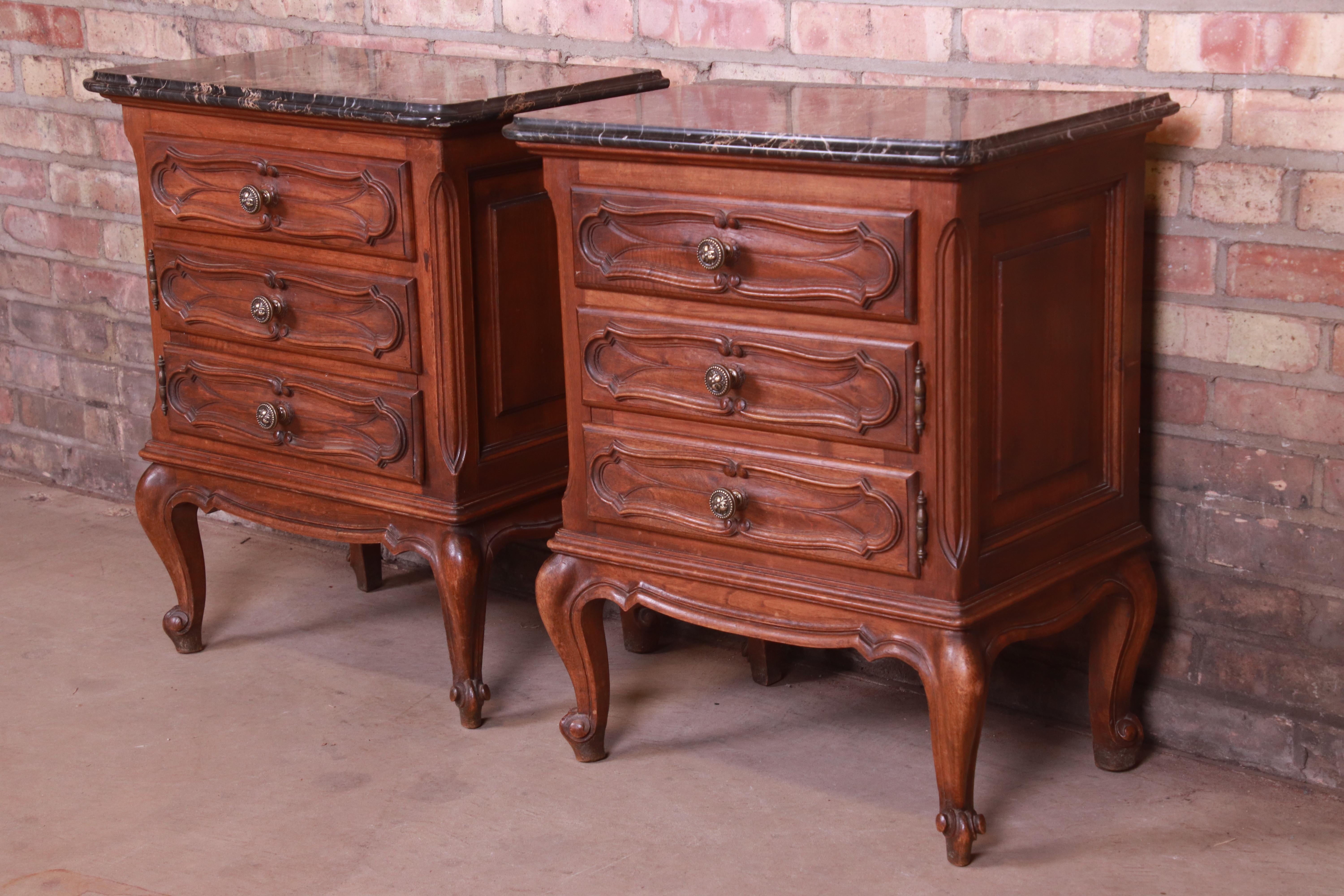 A gorgeous pair of Italian Louis XV style nightstands.

By Mobili Barovero Torino,

Italy, circa 1940s

Carved walnut, with beveled marble tops and brass hardware.

Measures: 21.63