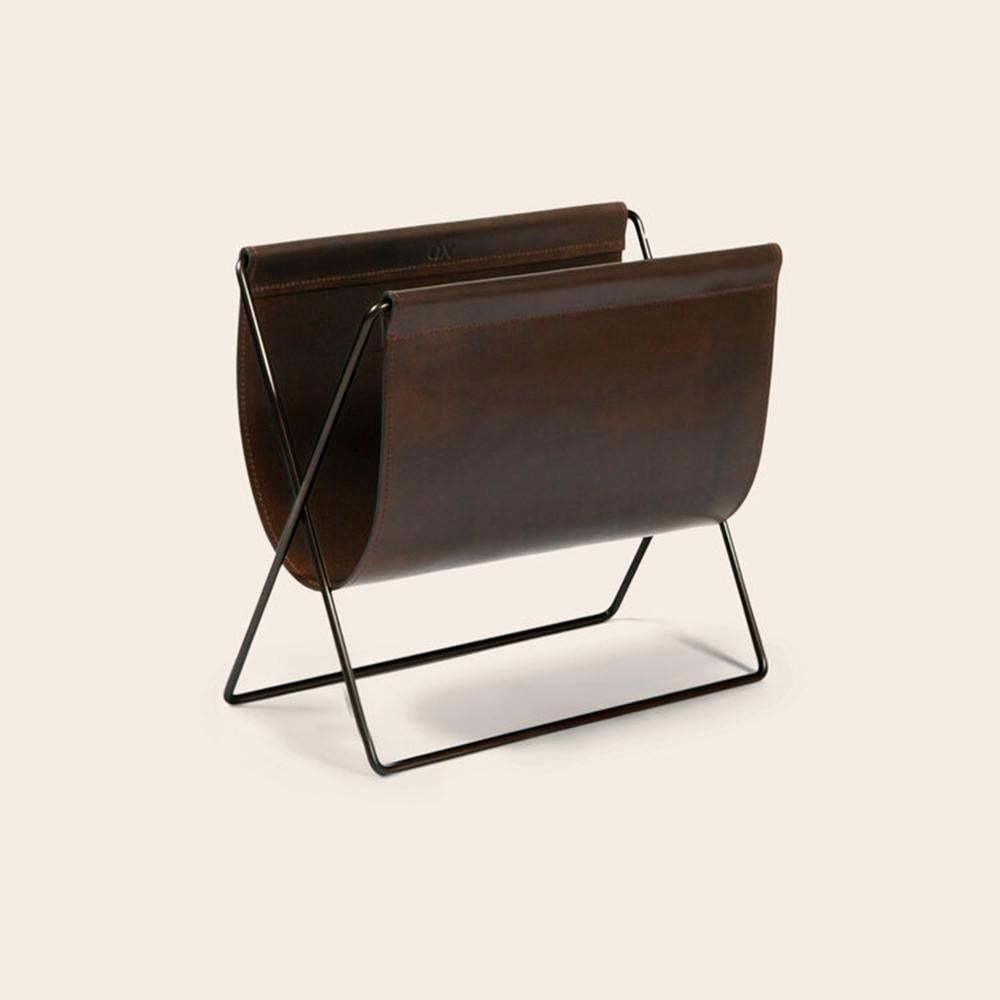 Mocca leather and black steel Maggiz Magazine rack by OxDenmarq
Dimensions: D 24 x W 47 x H 43 cm
Materials: Steel, leather
Also available: Different leather and frame colors available

OX DENMARQ is a Danish design brand aspiring to make