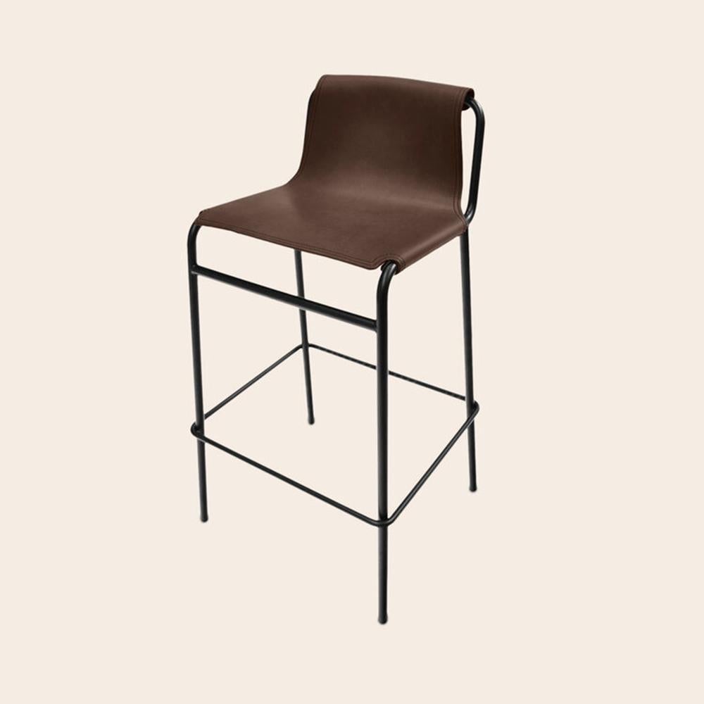 Mocca September Bar Stool by OxDenmarq
Dimensions: D 38 x W 42 x H 93 cm
Materials: leather, black powder coated steel
Also available: different colors available.

Ox Denmarq is a Danish design brand aspiring to make beautiful handmade