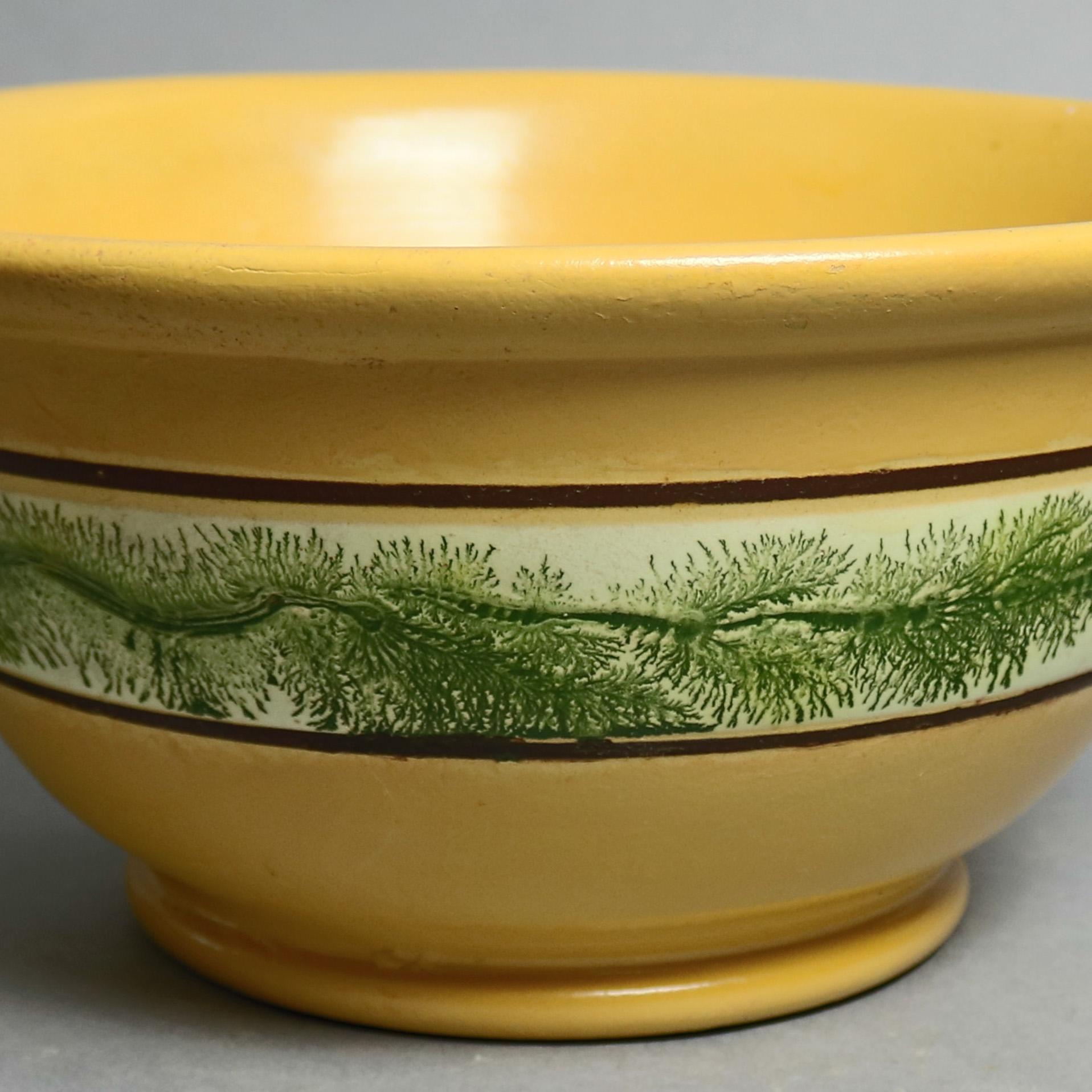 Mocha yellow ware mixing bowl by East Knoll Pottery features flared form with band of feathered decoration, maker mark impressed in base, 20th century


Measures - 13.5