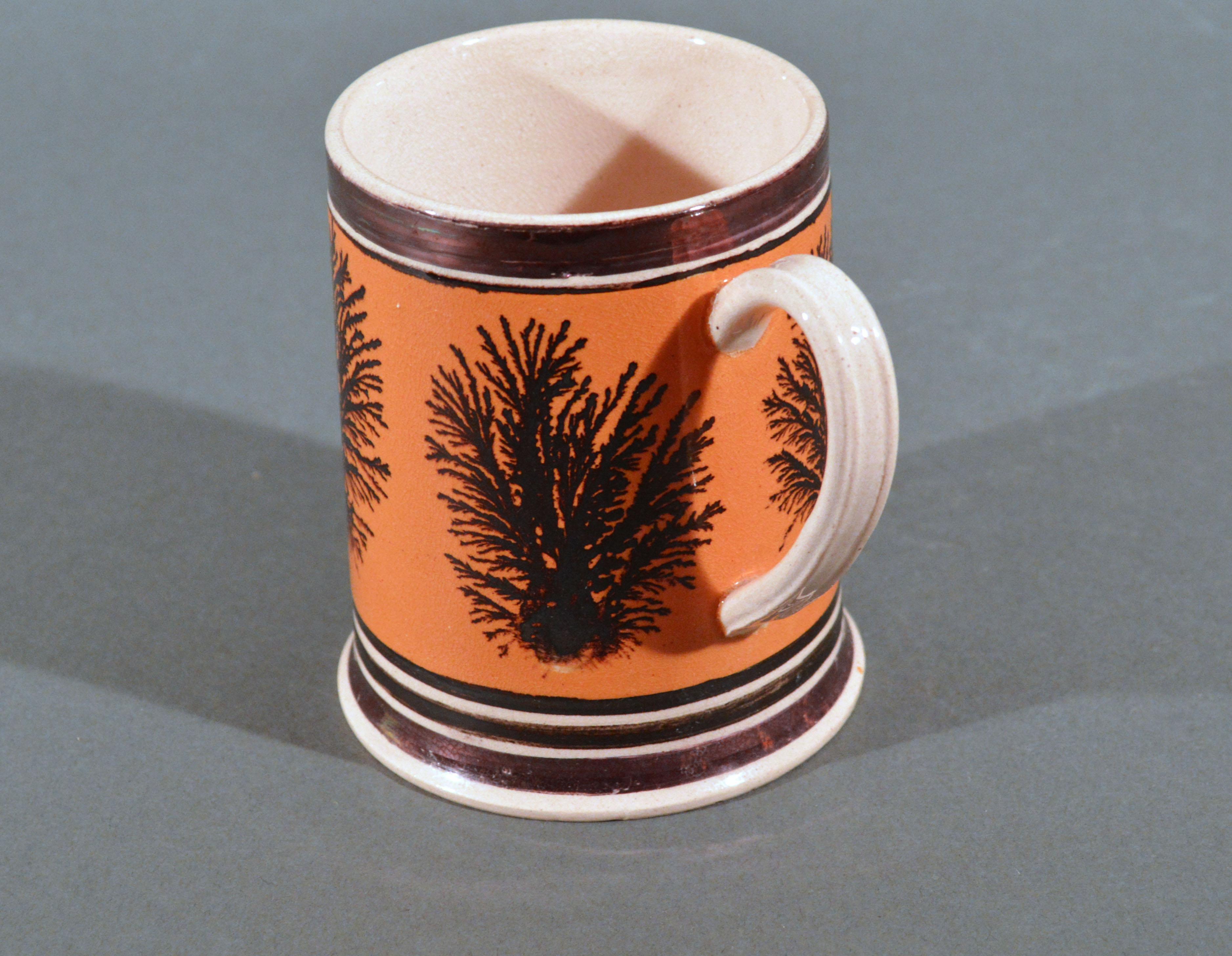 Mocha Pottery Mug with Luster and Seaweed Decoration, 
England,
Circa 1825

The Mocha pottery is unusually decorated with a coffee-colored slip ground with seaweed or dendritic design with rare luster bands around the neck and