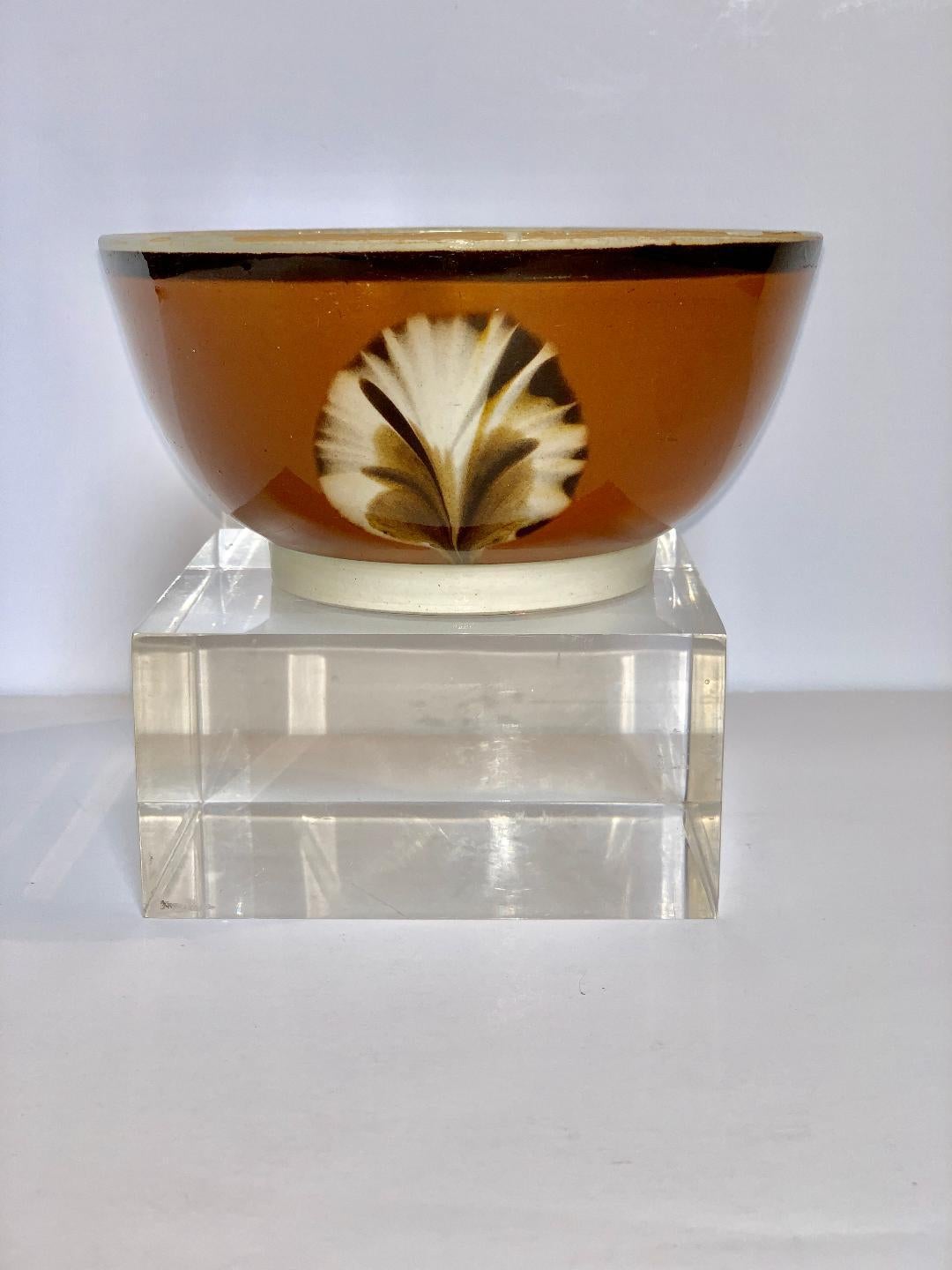We are excited to offer this mocha ware bowl with dipped fan decoration. Made in England, circa 1800. This bowl is one of our rarest and best pieces. The bowl has a medium brown slipware ground (the rim has very slight fritting) and is decorated