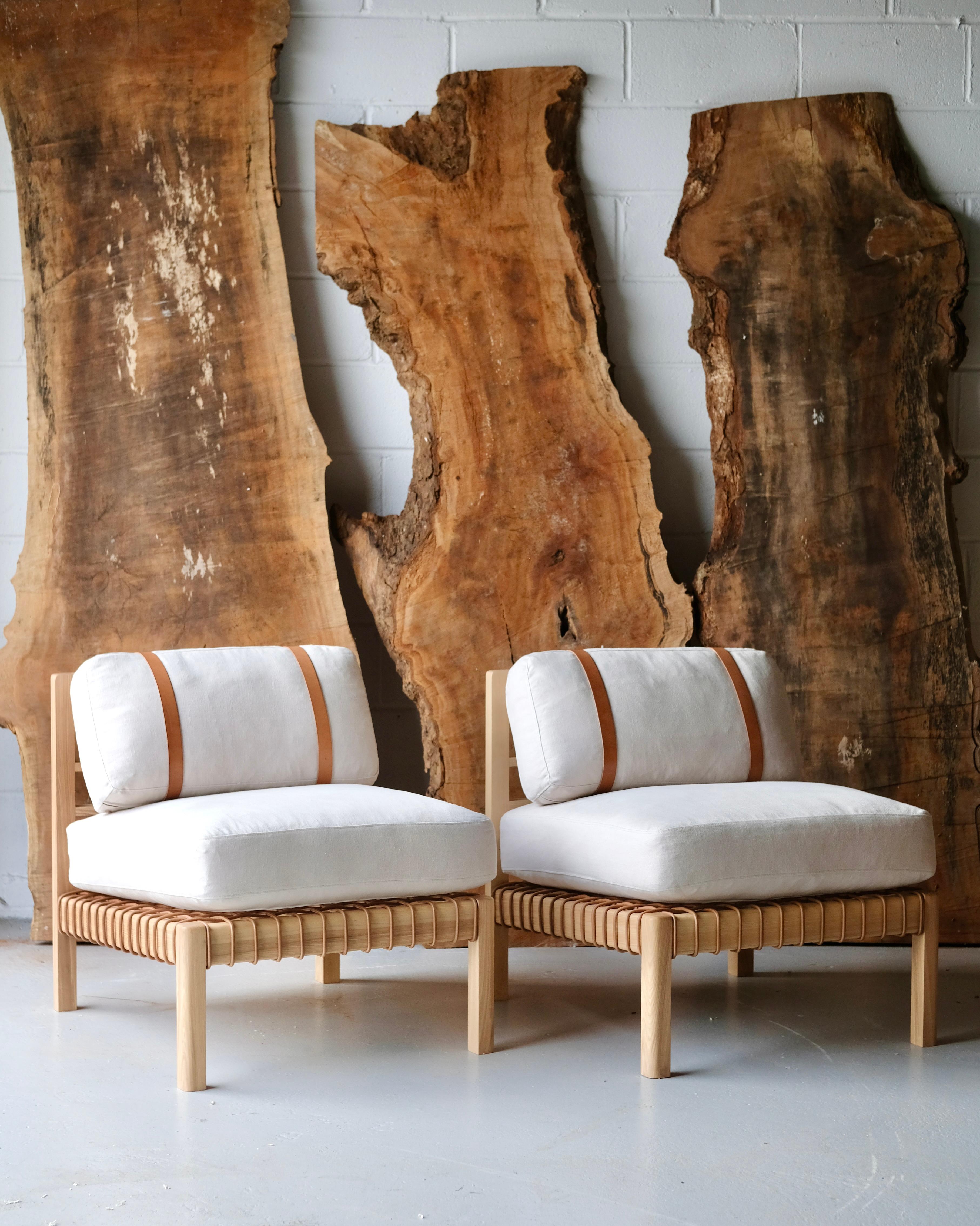 Large panels of meticulously stitched French linen or whole shoulders of Tuscan vegetable tanned leather form the basis for this exposed timber framed easy chair. The Mochi uses three types of leatherwork to create a simple but beautifully detailed