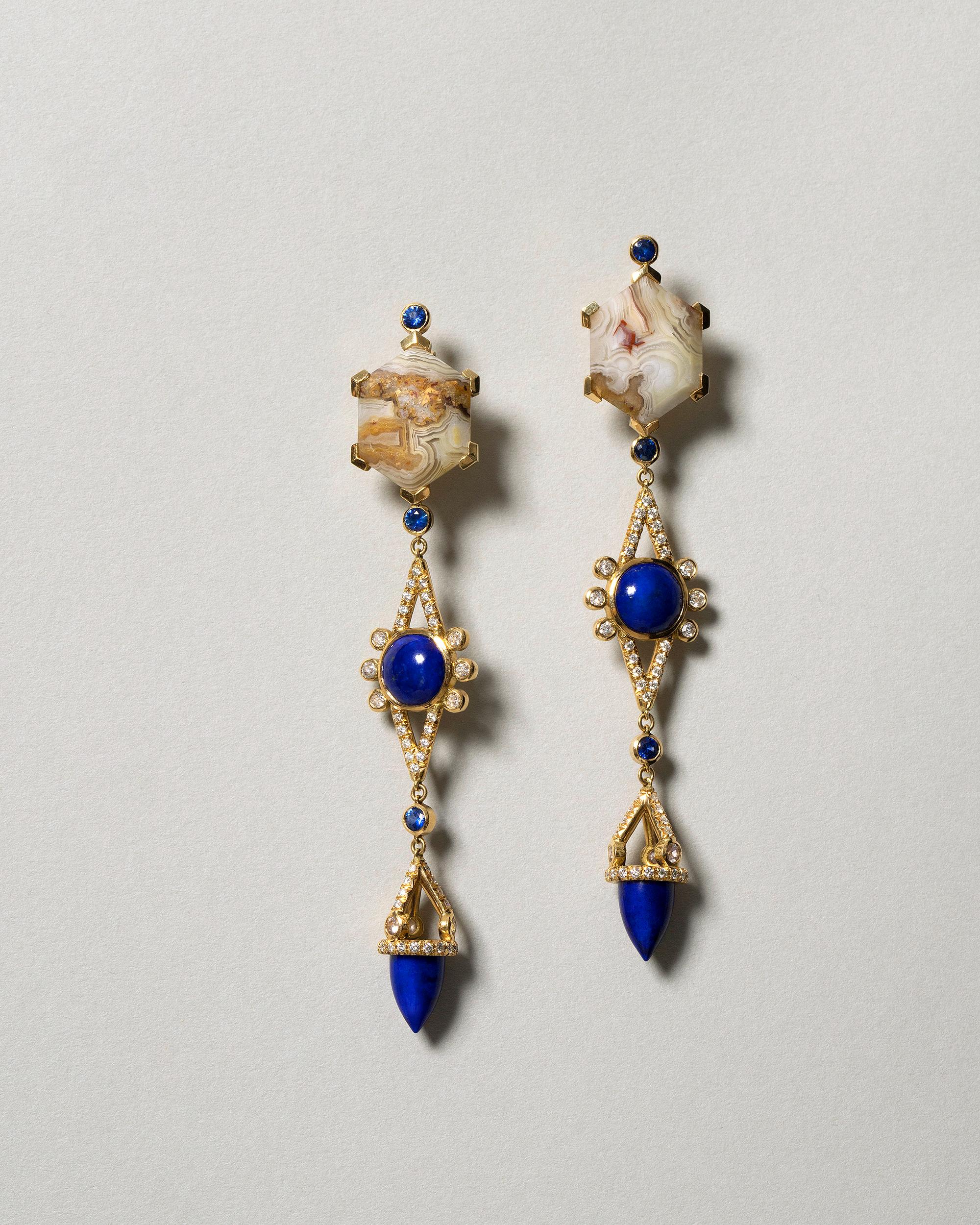 One of a kind earrings
2 lace agate hexagons have a total gem weight of 12.76ct

6 blue sapphires have a total gem weight of .45ct

2 round lapis cabochons have a total gem weight of 3.62ct

2 bullet cut lapis have a total gem weight of 4.67ct

23