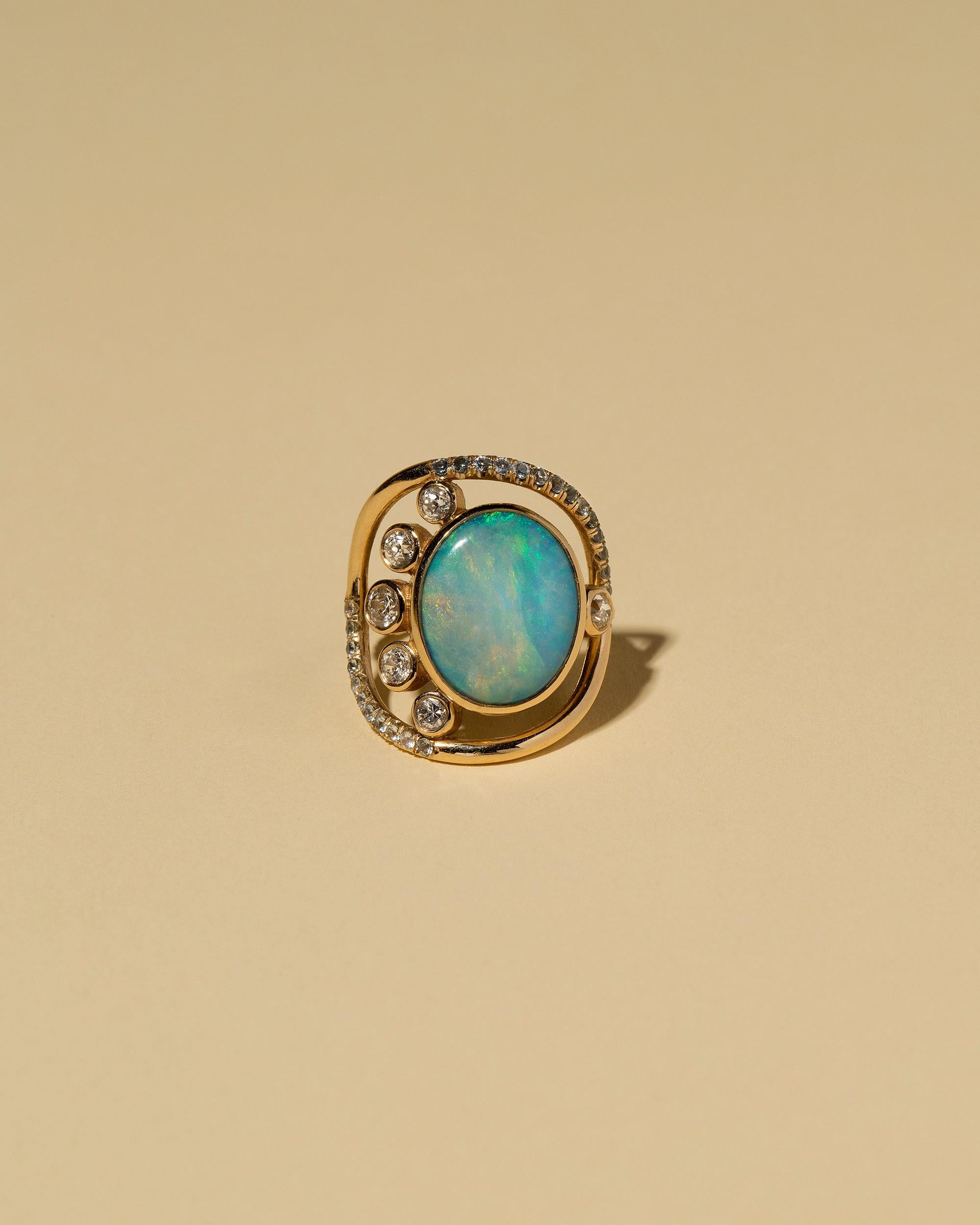 One-of-a-kind stone cluster ring

Australian, black opal cabochon weighs 4.29 ct.

Six bezel set, round cut, white diamonds have a total gem weight of 0.48 ct.

Thirty-one pavé set, blue, Montana sapphires have a total gem weight of 0.37 ct.

Round