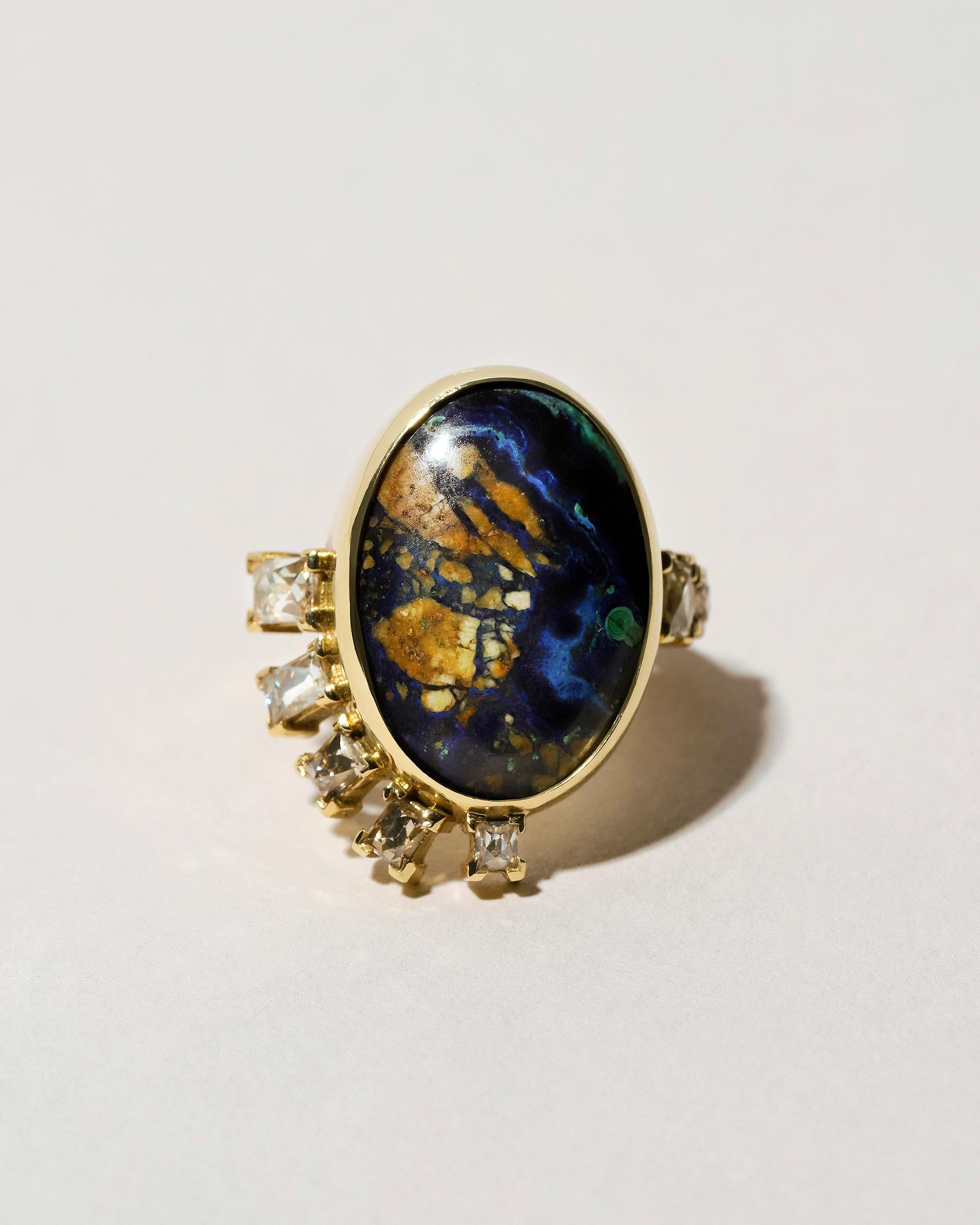One-of-a-kind cluster ring

Oval cut, azurite malachite cabochon weighs 9.57 ct. and measures 19.85mm by 13.90mm

Three French cut, white diamonds have a total gem weight of 0.59 ct.

Two French cut, champagne diamonds have a total gem weight of