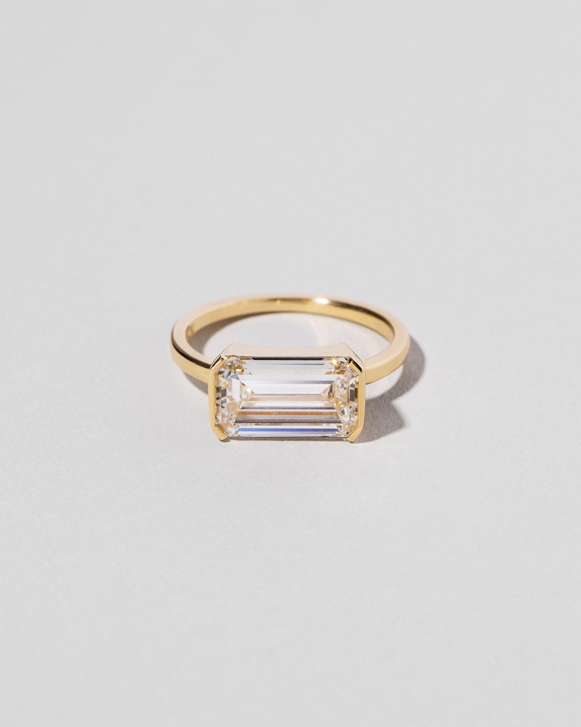 One-of-a-kind solitaire 
Emerald cut diamond (G/VVS2) weighs 3.16 ct.
Stone is secured in a modified bezel setting
Square wire band measures 1.7mm
Set in 18k yellow gold

All of our pieces are made by hand in NYC. Please allow two weeks for resizing.