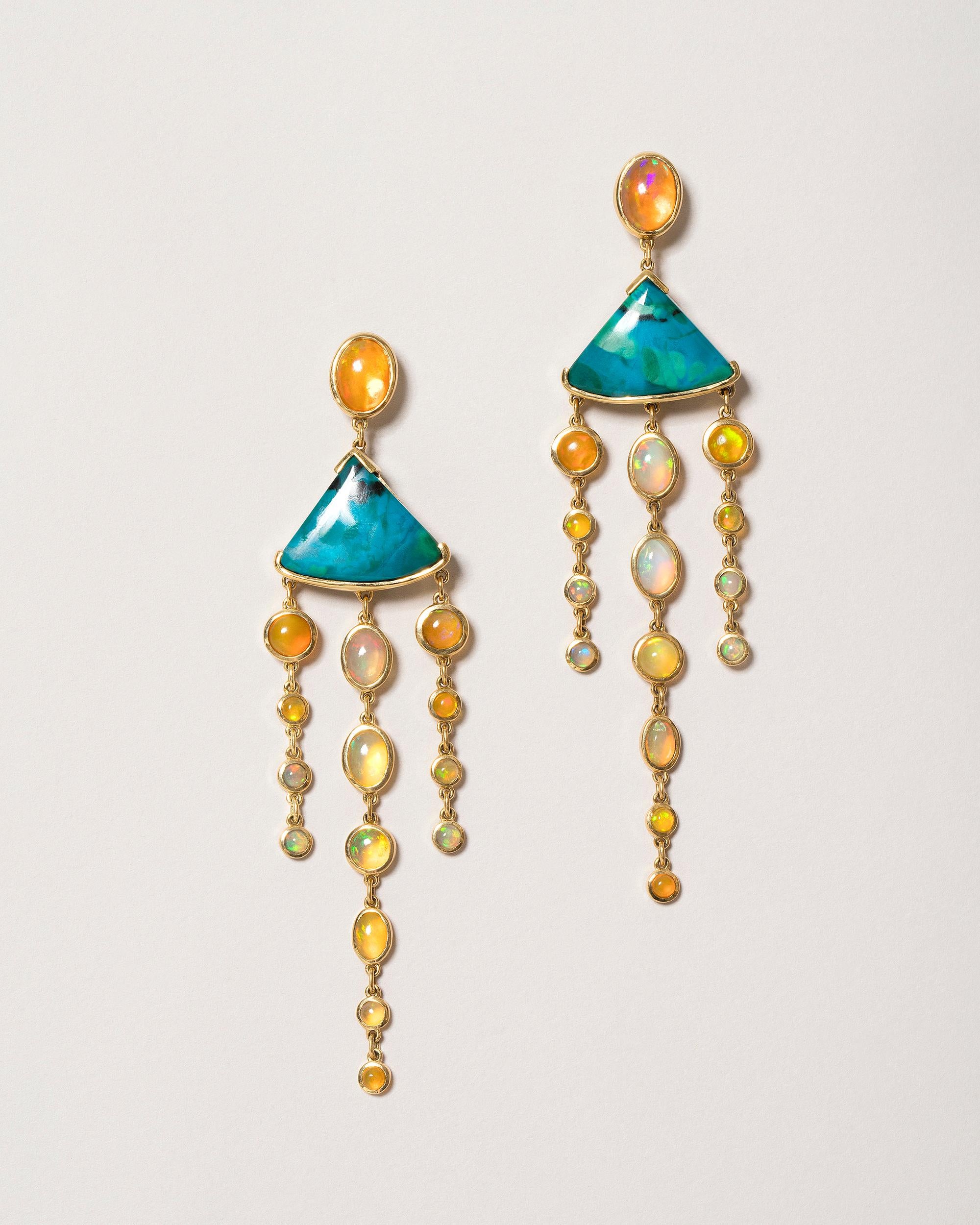 One of a kind earrings
2 chrysocolla cabochons have a total gem weight of 15.03ct

30 Ethiopian opals have a total gem weight of 8.58ct

Set in 18k yellow gold