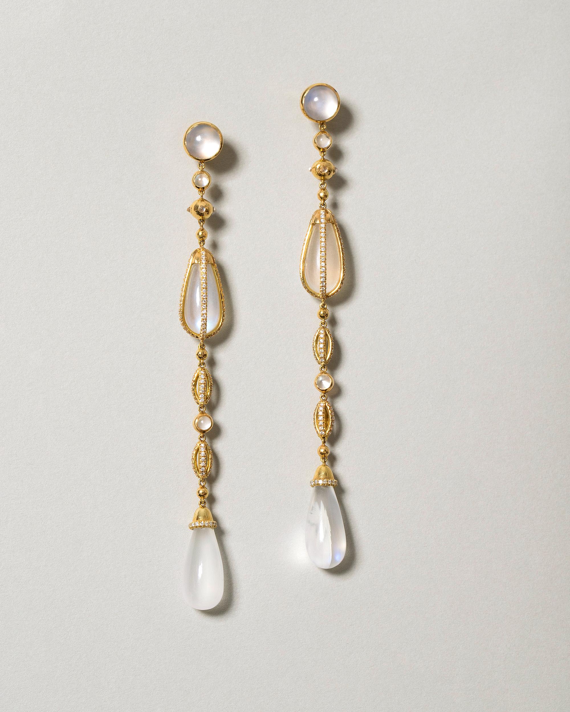 One of a kind earrings
300 pavé set white diamonds (G/SI2) have a total gem weight of .64ct

2 round Ceylon moonstone cabochons measure 2 x 7mm

2 round Ceylon moonstone drops measure 18mm in length

2 round Ceylon moonstone drops measure 15mm in