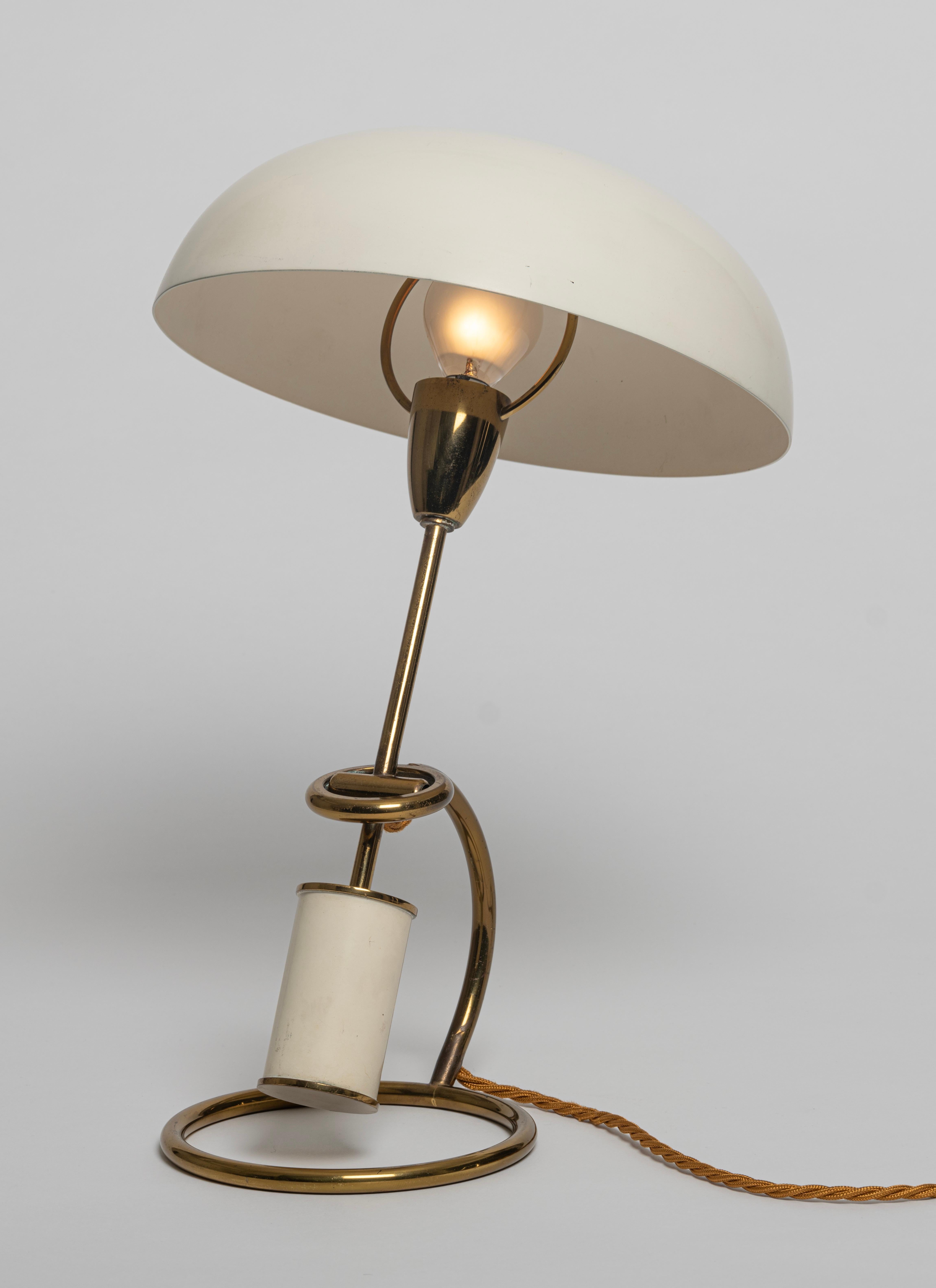 A rare Mod. 12297 table or desk lamp designed by Angelo Lelii for Arredoluce, Italy, c.1950. Along with his 'Trienniale' floor lamp, this brass and cream painted-aluminium table lamp is one of Angelo Lelii's most iconic designs. The body of the lamp