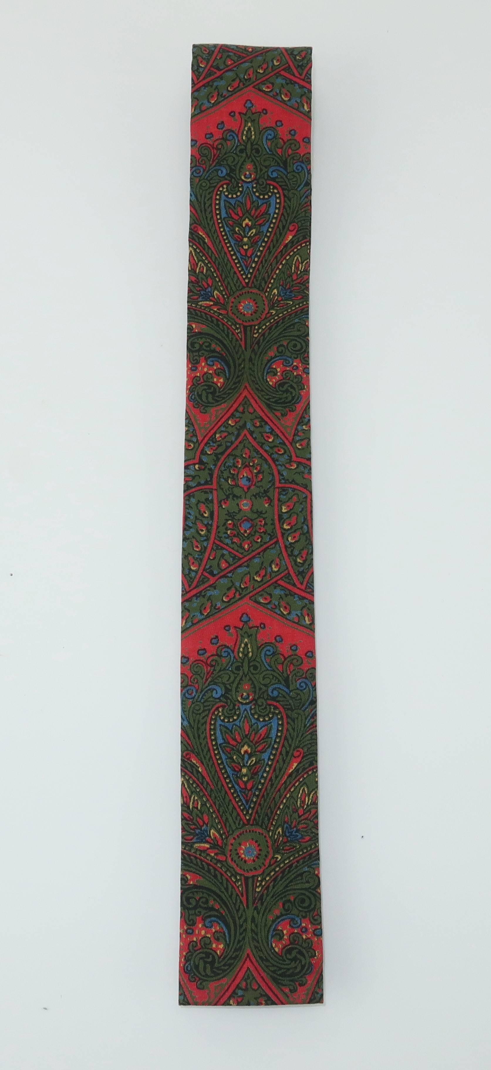 The novelty necktie can be the perfect accessory for a gentleman with both a sense of humor and style.  This 1960's skinny square tie is by Taylor, Ludlow Vermont.  It is fabricated from a cotton blend paisley fabric incorporating a dark orangey