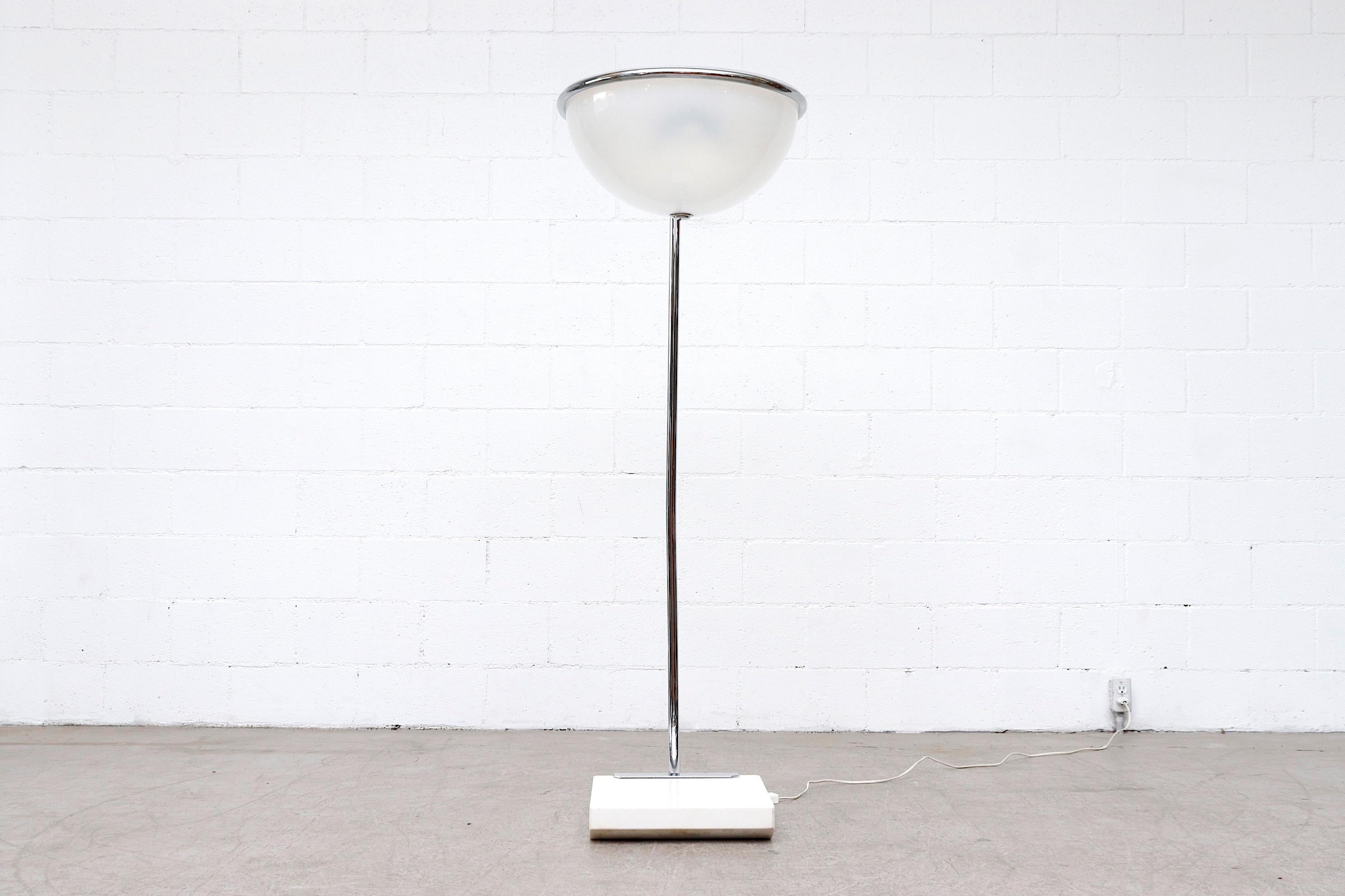 Awesome 1970s modern floor lamp from a Town Hall in the Netherlands. Lamp has a fat tubular chrome frame, heavy marble base and plexiglass domed shade. In original condition with visible wear, including scratching, and some chipping to marble.