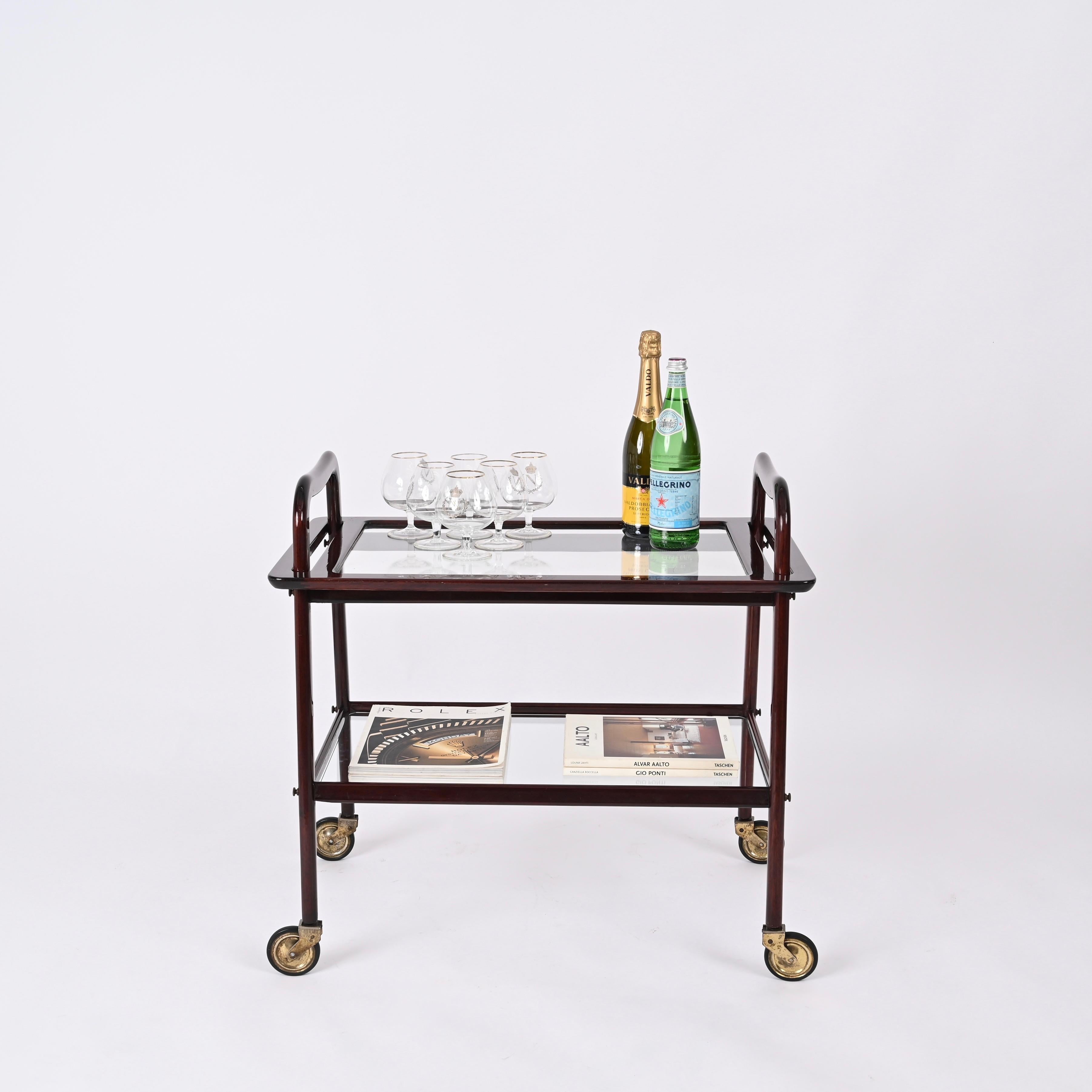 Wonderful service bar trolley designed by the master of Italian design Ico Parisi together with his wife Luisa. The cart was produced by De Baggis in the 1950s in Italy.

The wood quality of this elegant bar cart is exceptional and the sinuous lines