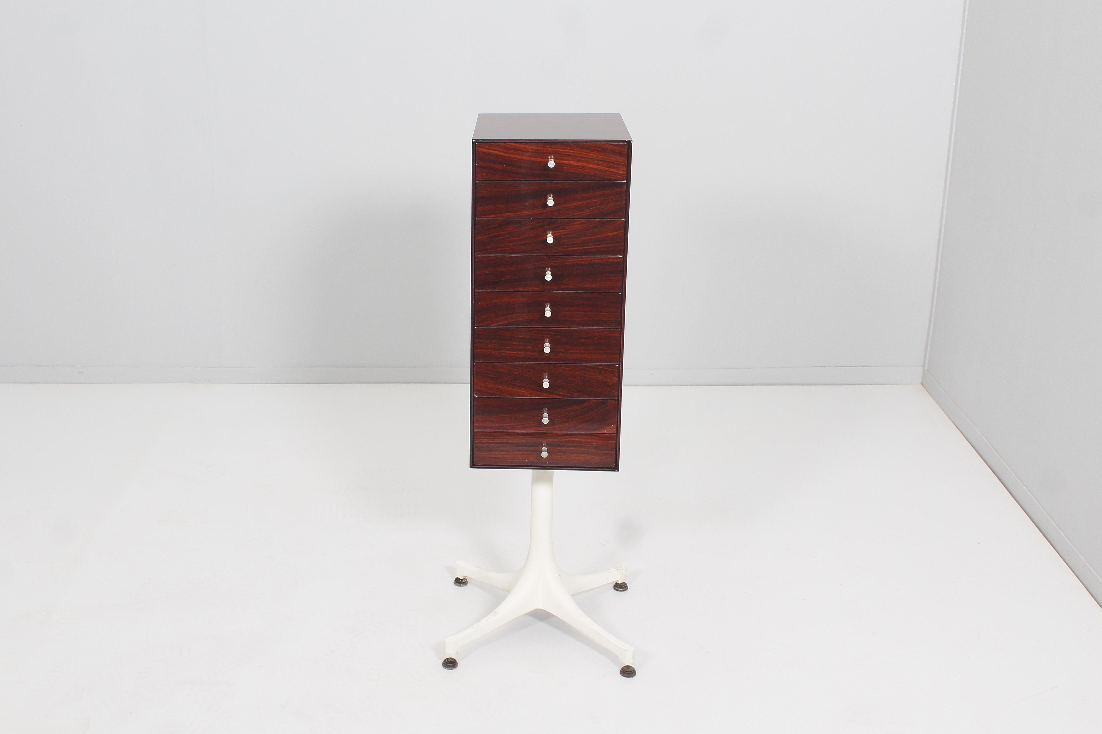 Elegant vertical chest of drawers with four supports in white lacquered die-cast aluminium.
In the first of the nine drawers there are jewelery compartments. Model no. 5517 by George Nelson for Herman Miller, 1950s. Restored. 
Wear consistent with