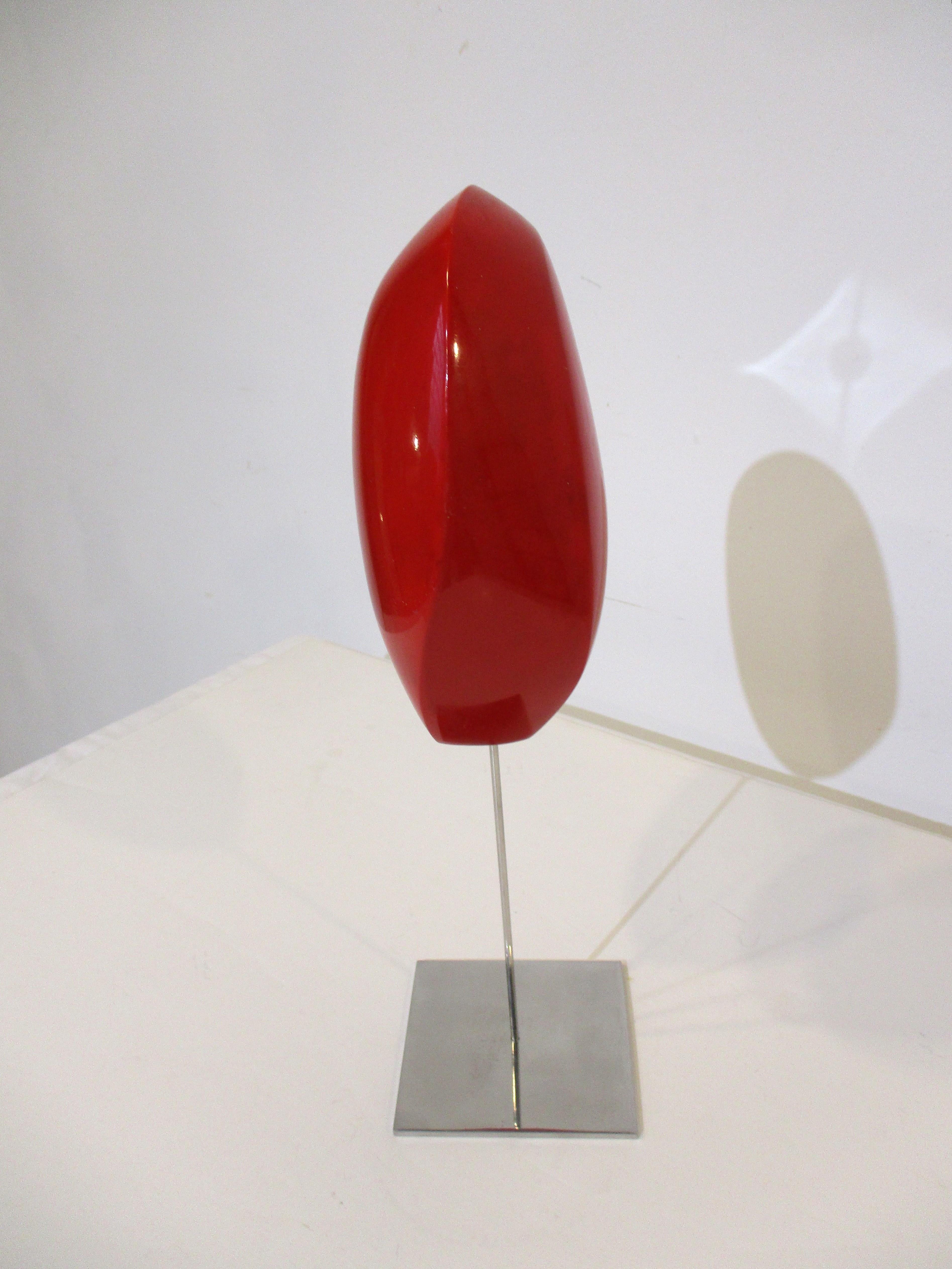 A very organic formed modern styled fiberglass sculpture in a blend of reds mounted on a chromed staff with chromed steel base. Made in the 1960's by Bucks county Pennsylvania artist Lawrence E. Glasson who's paintings, sculptures and objects were
