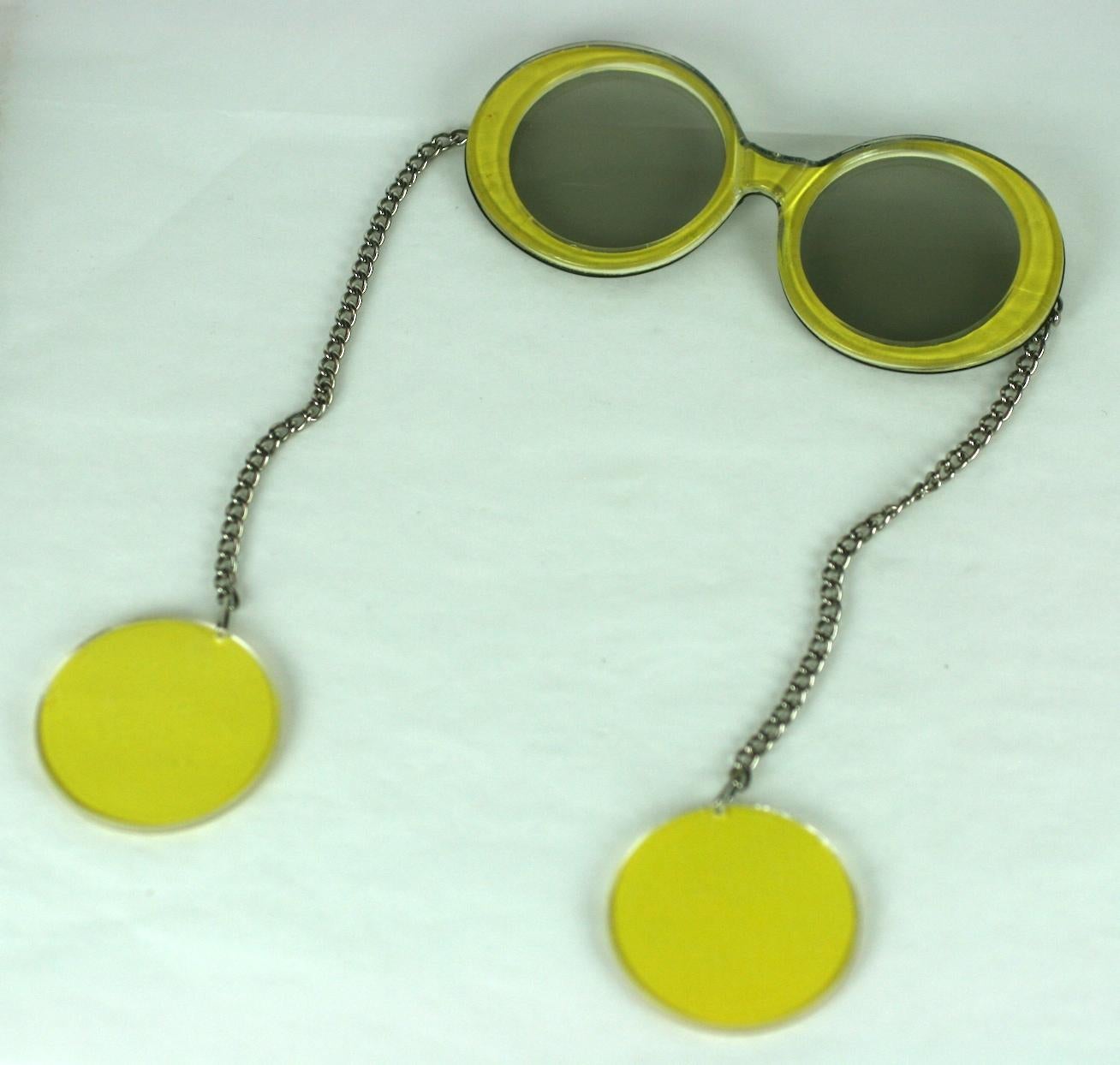 Fun Mod Glasses with Earrings Combo from the 1960's.  Instead of arms, there are chains with suspended yellow plastic discs which form earrings when worn. 1960's USA. 
5.5
