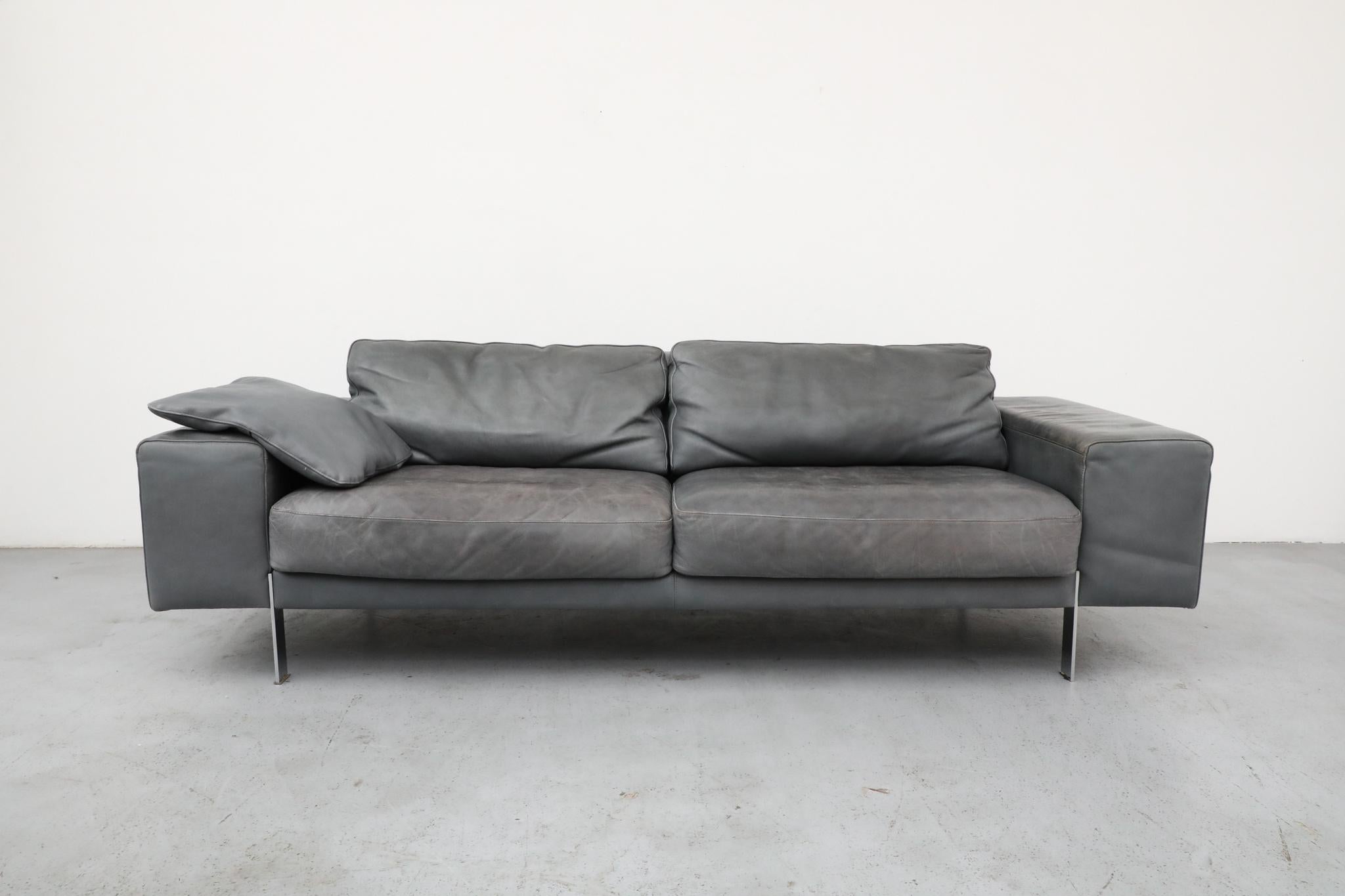 Mid-Century gray leather two-seater sofa by Italian manufacturer Molinari, styled in the spirit of Dutch designer Gerard van den Berg. This piece embodies the relaxed, low-slung elegance and soft, deconstructed aesthetic often seen in van den Berg's