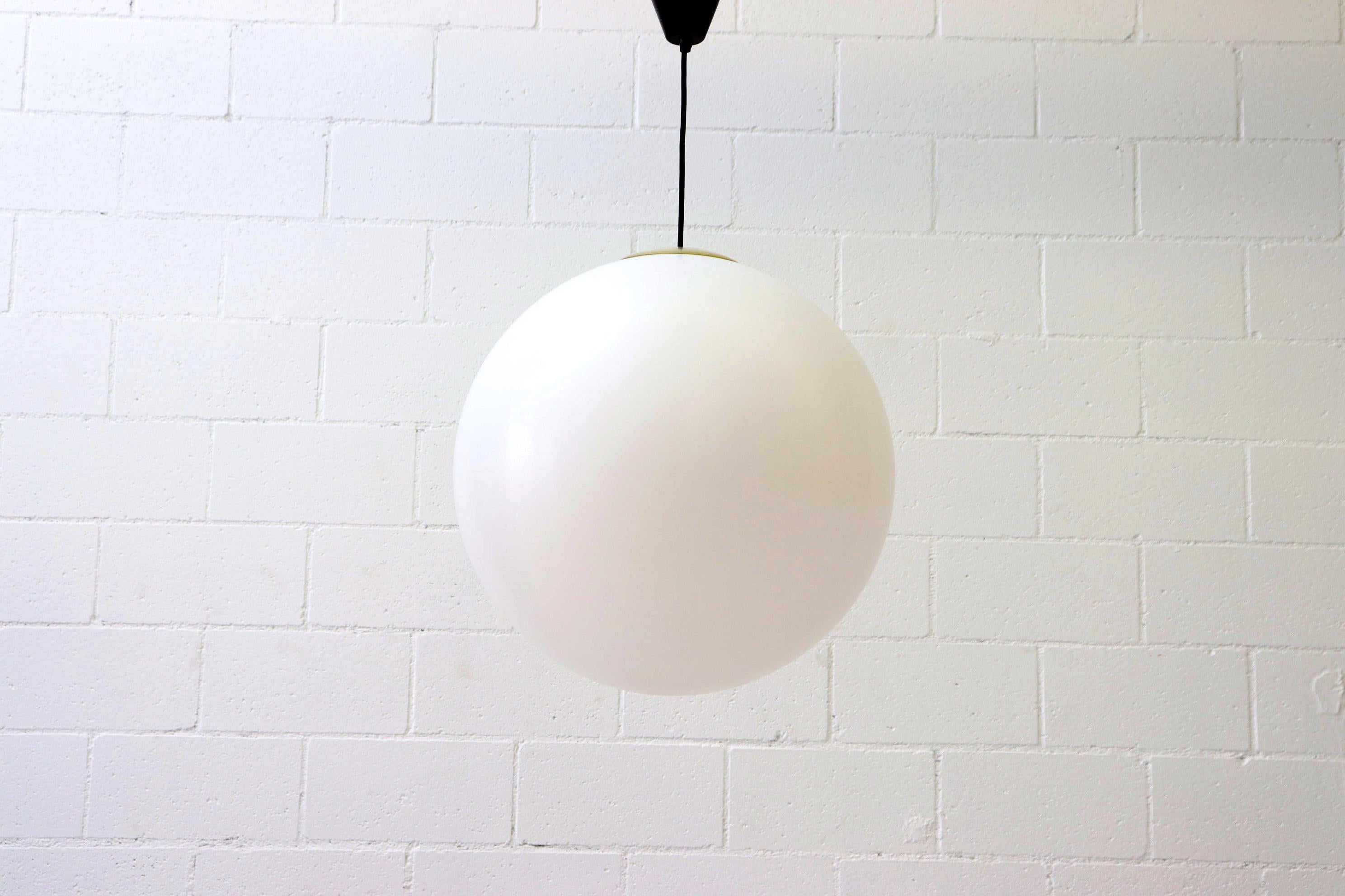 Extra large white acrylic globe lights with clear plastic hardware, black plastic canopy and standard light socket. In original condition with some visible wear consistent with their age and usage.