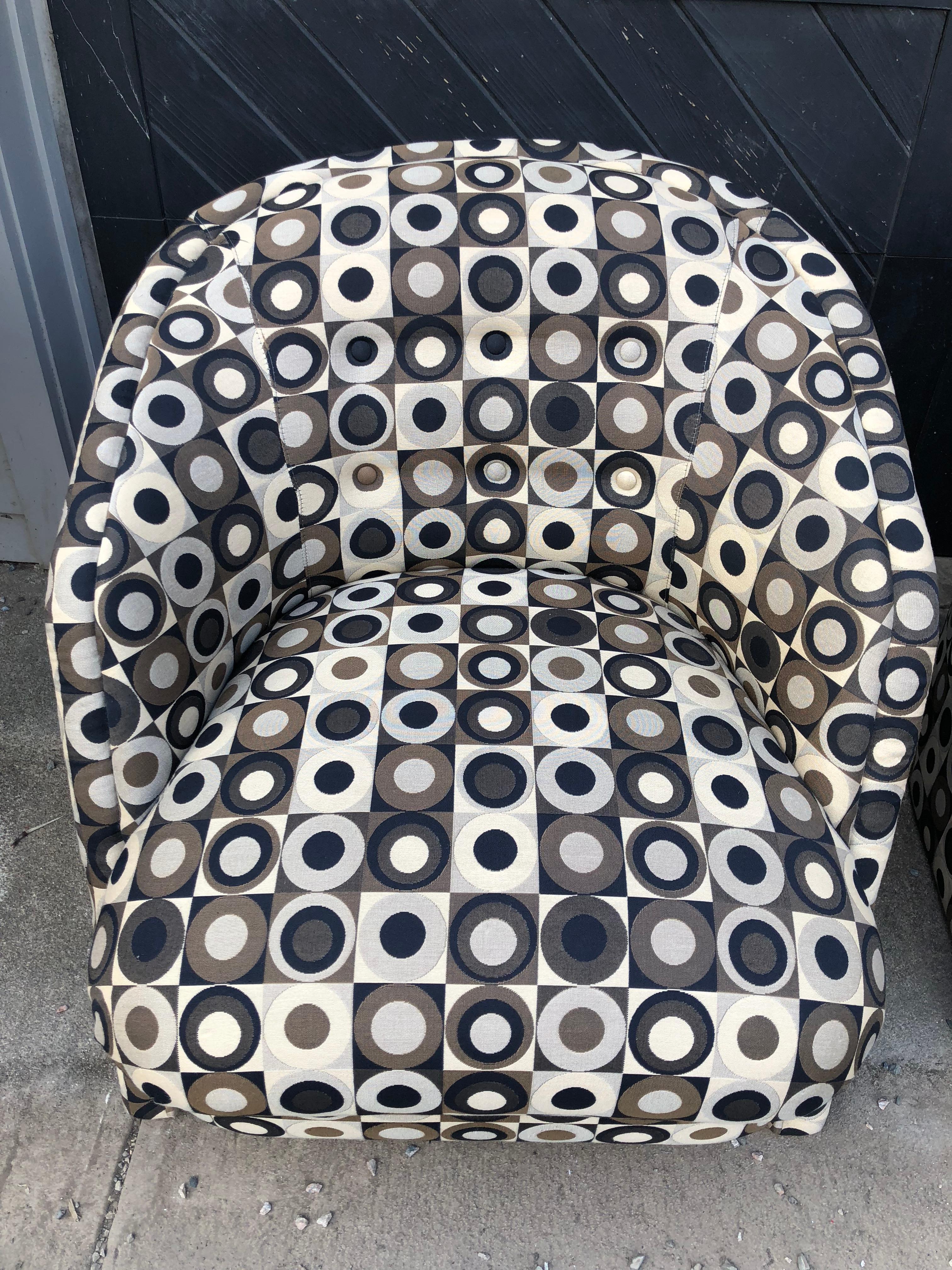 Funky pair of mid century modern club chairs having mod graphic geometric original fabric in earth tones including black, camel and brown. Reminiscent of Marimekko fabric. Made by The Preview Furniture company. Measures: Seat height 18, seat arm