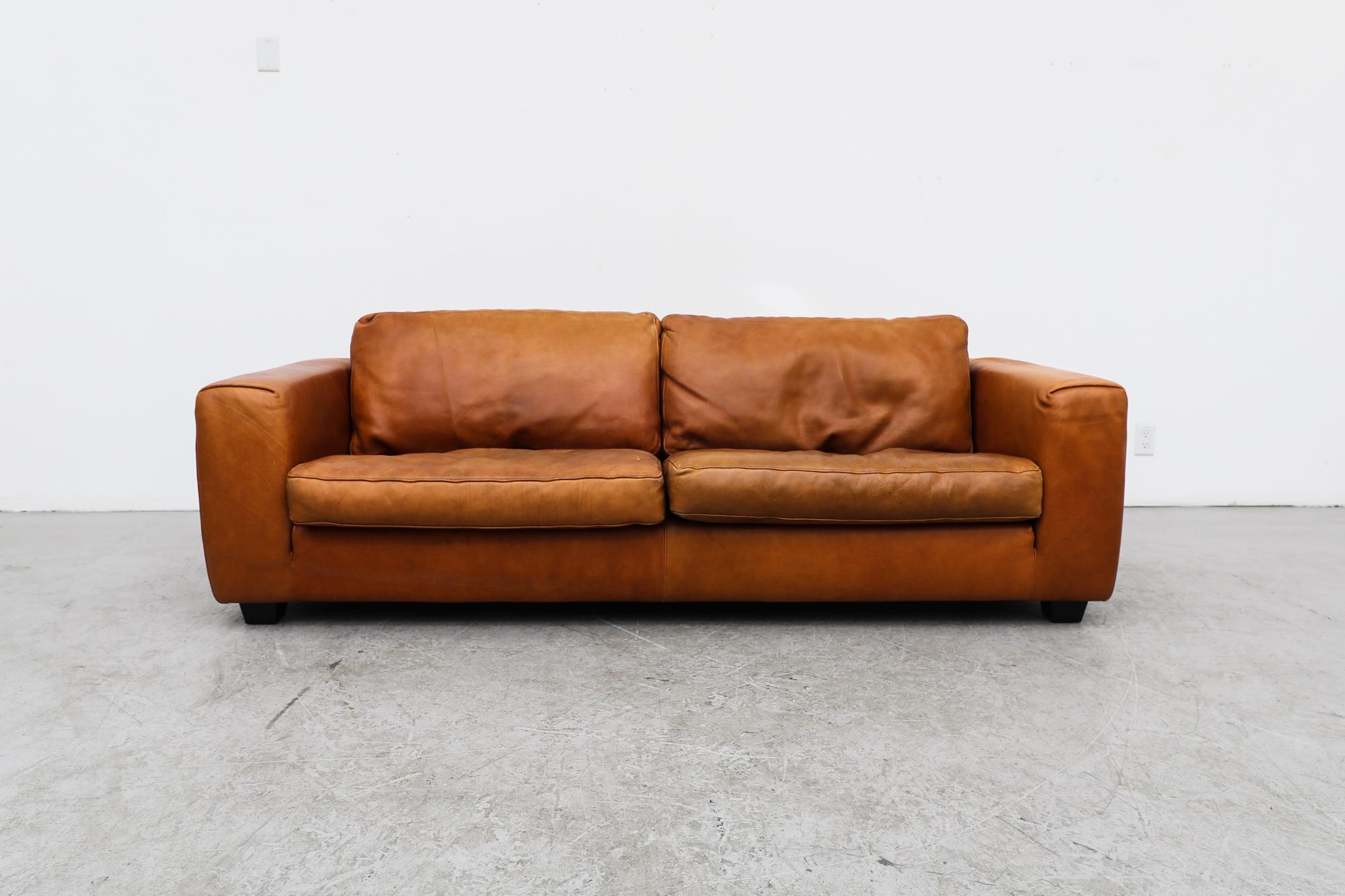 MOD Leather 3 seater 'Senza Tempo M' Sofa designed for the Dutch furniture company Linteloo Lab. Upholstered in a warm cognac leather with wide armrests and blocky wooden feet. In original condition with wear consistent with its age and use.