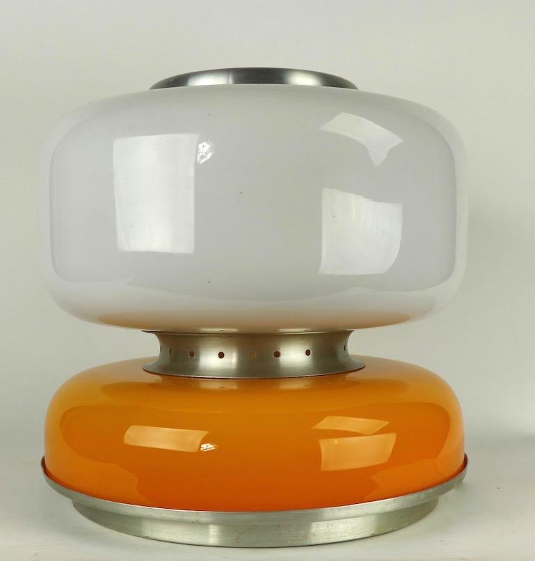 Sophisticated and chic two section glass table lamp attributed to Carlo Nason for Mazzega. The lamp consists of a lower glass section of tan/yellow/orange color, and an upper section of white glass. It has spun aluminum spacer pieces, base top etc.